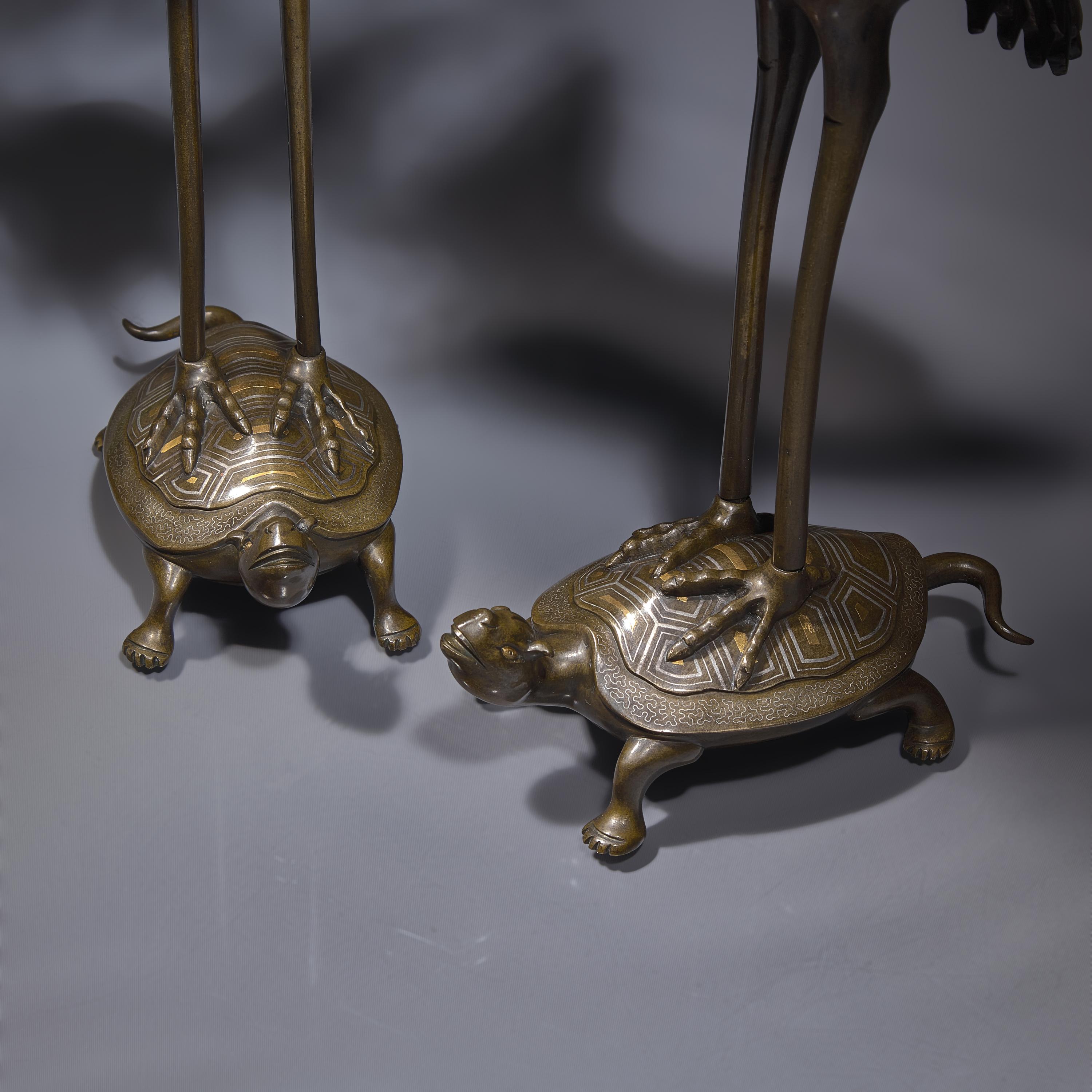 A Pair of Japanese Kaga Style Inlaid Bronze 'Crane and Minogame' Candelabra, Meiji Period — 日本明治時期 銅龜鶴齊齡燭臺一對