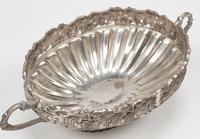 A Set of Four Silver-Plate Handled Dishes