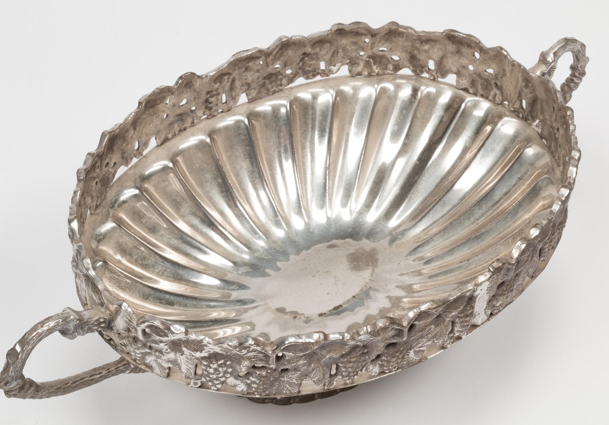 A Set of Four Silver-Plate Handled Dishes