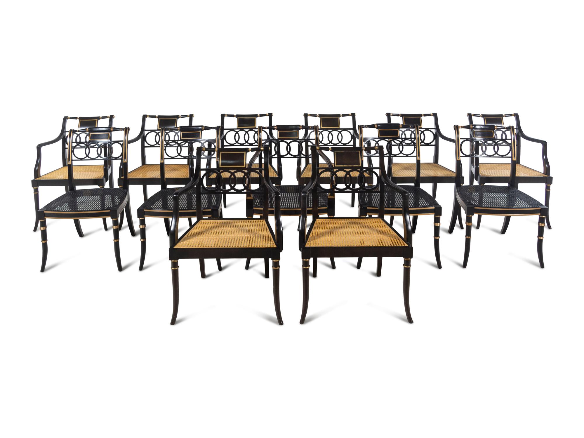 Thirteen Baker Regency Style Ebonized and Parcel Gilt Cane Seat Armchairs
