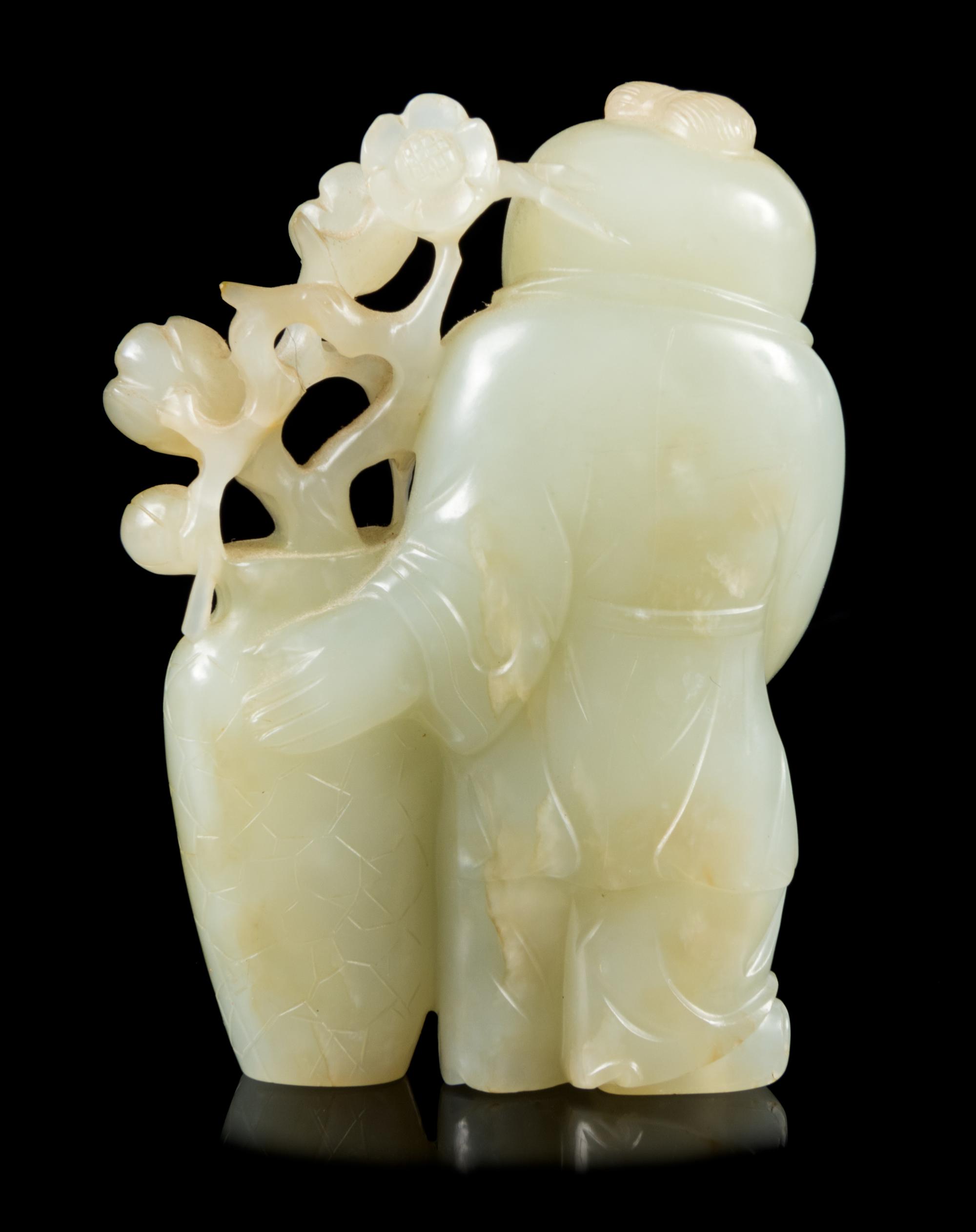 A Carved Celadon Jade Figure of a Boy Height 2 3/4 inches. — 19TH CENTURY