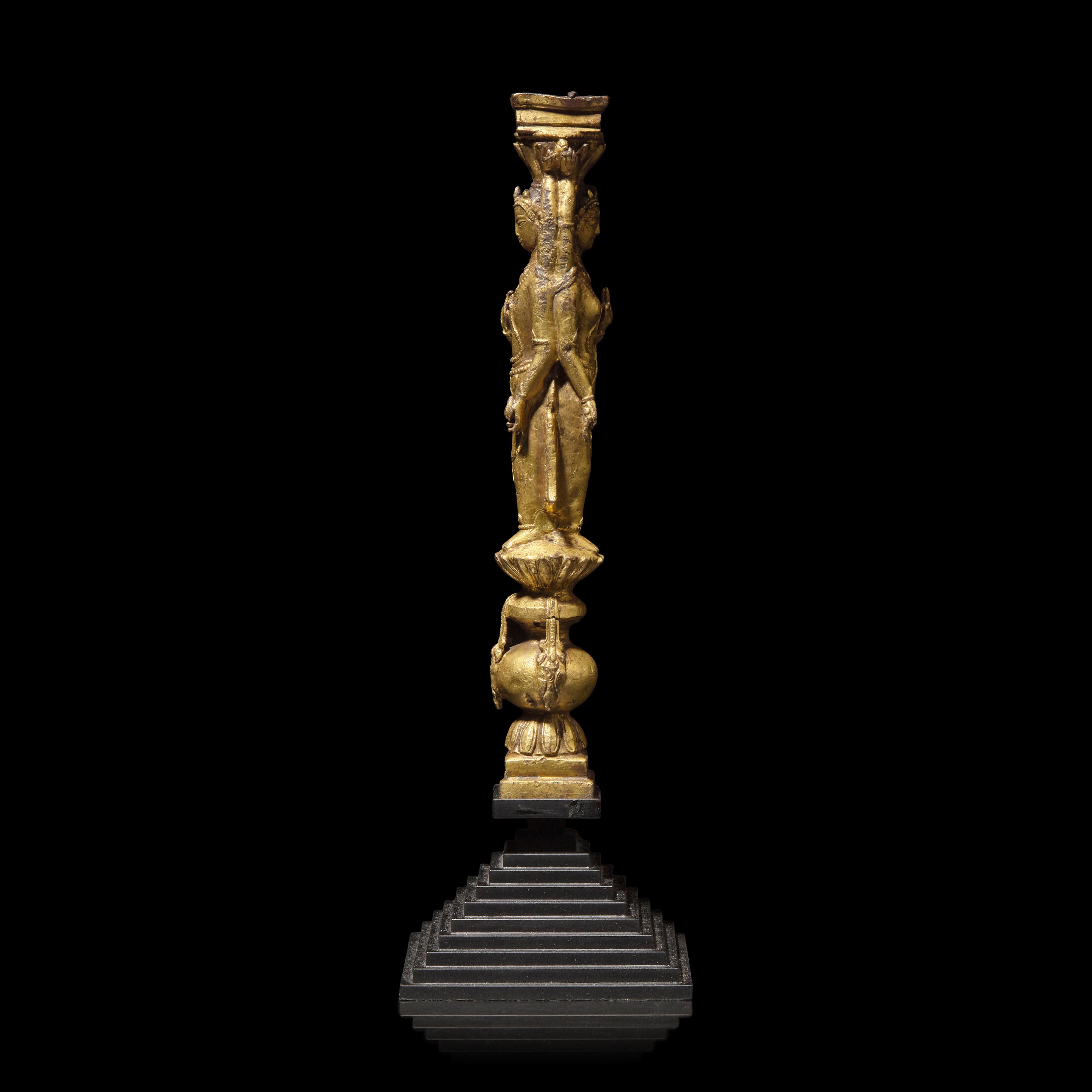 A Tibetan Gilt Copper Alloy Double-Sided Stupa Column Support, Densatil Monastery, 14th/Early 15th Century