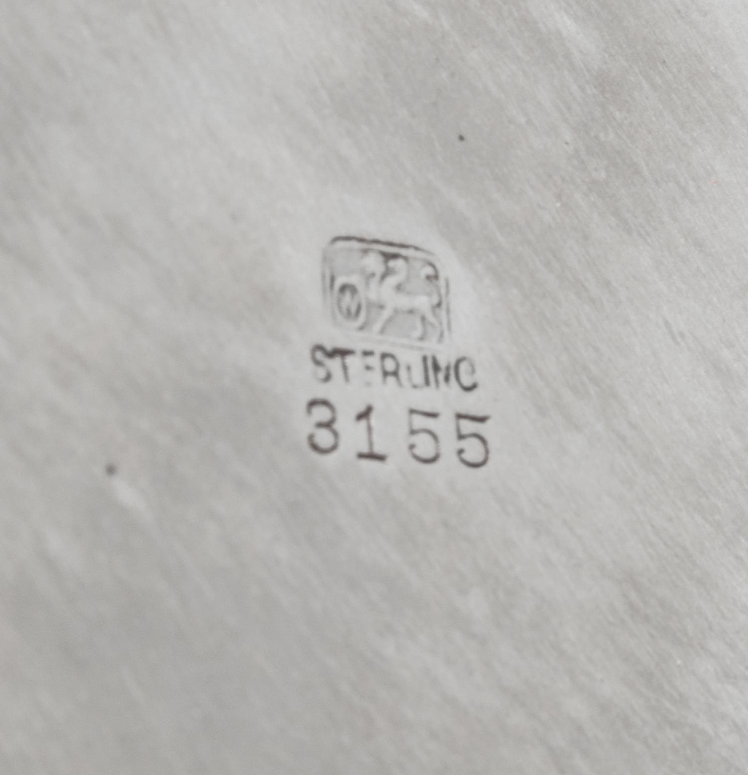 An American Silver Tray, Whiting Manufacturing Co., New York, NY, of circular form with an applied foliate scroll border, centered with