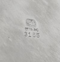 An American Silver Tray, Whiting Manufacturing Co., New York, NY, of circular form with an applied foliate scroll border, centered with