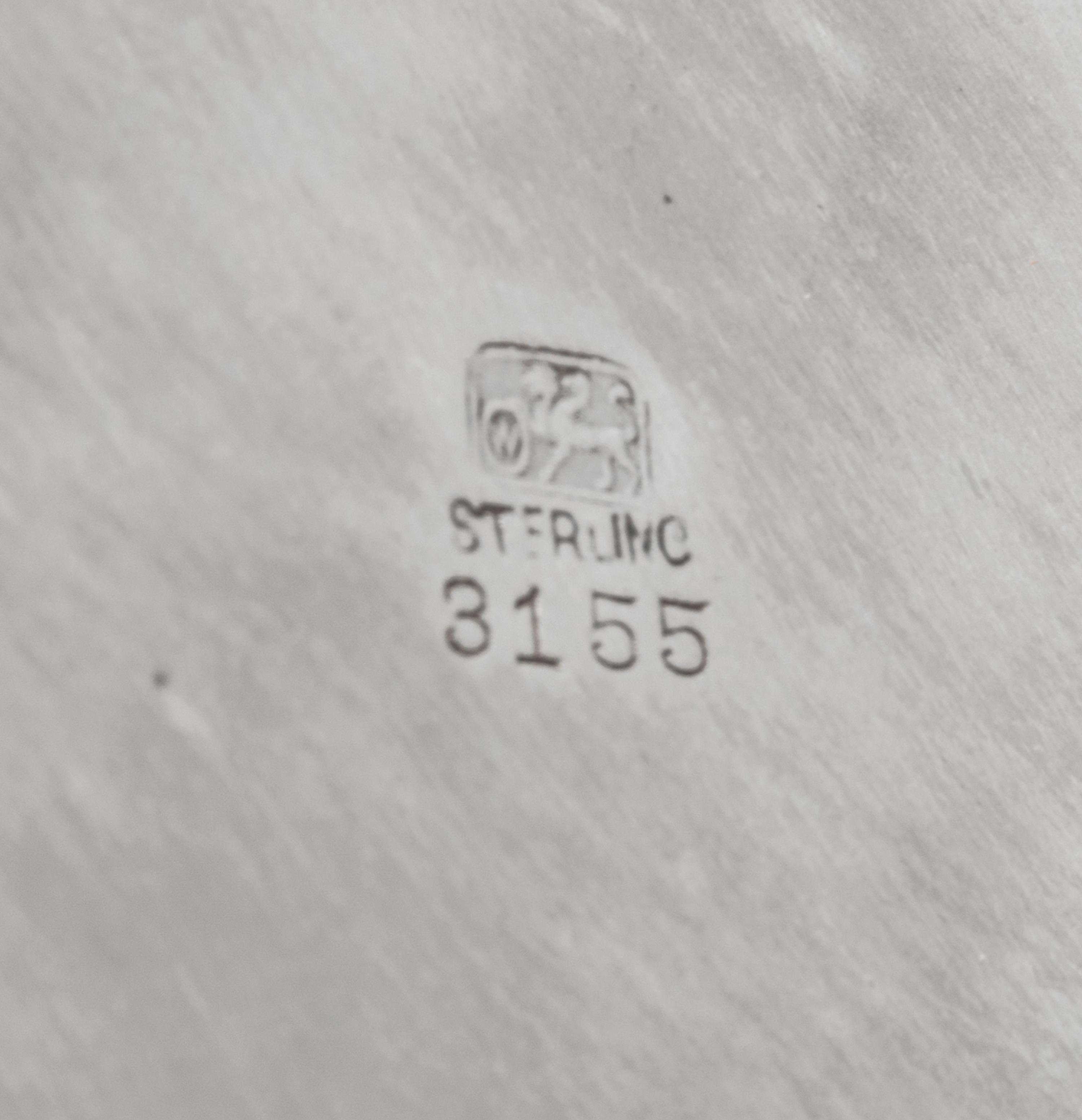An American Silver Tray, Whiting Manufacturing Co., New York, NY, of circular form with an applied foliate scroll border, centered with