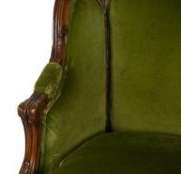 A Louis XV Style Carved Fruitwood Bergère à Oreilles