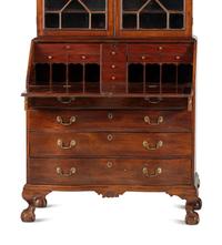 A Chippendale Mahogany and Cherrywood Serpentine Claw-and-Ball Foot Desk-and-Bookcase