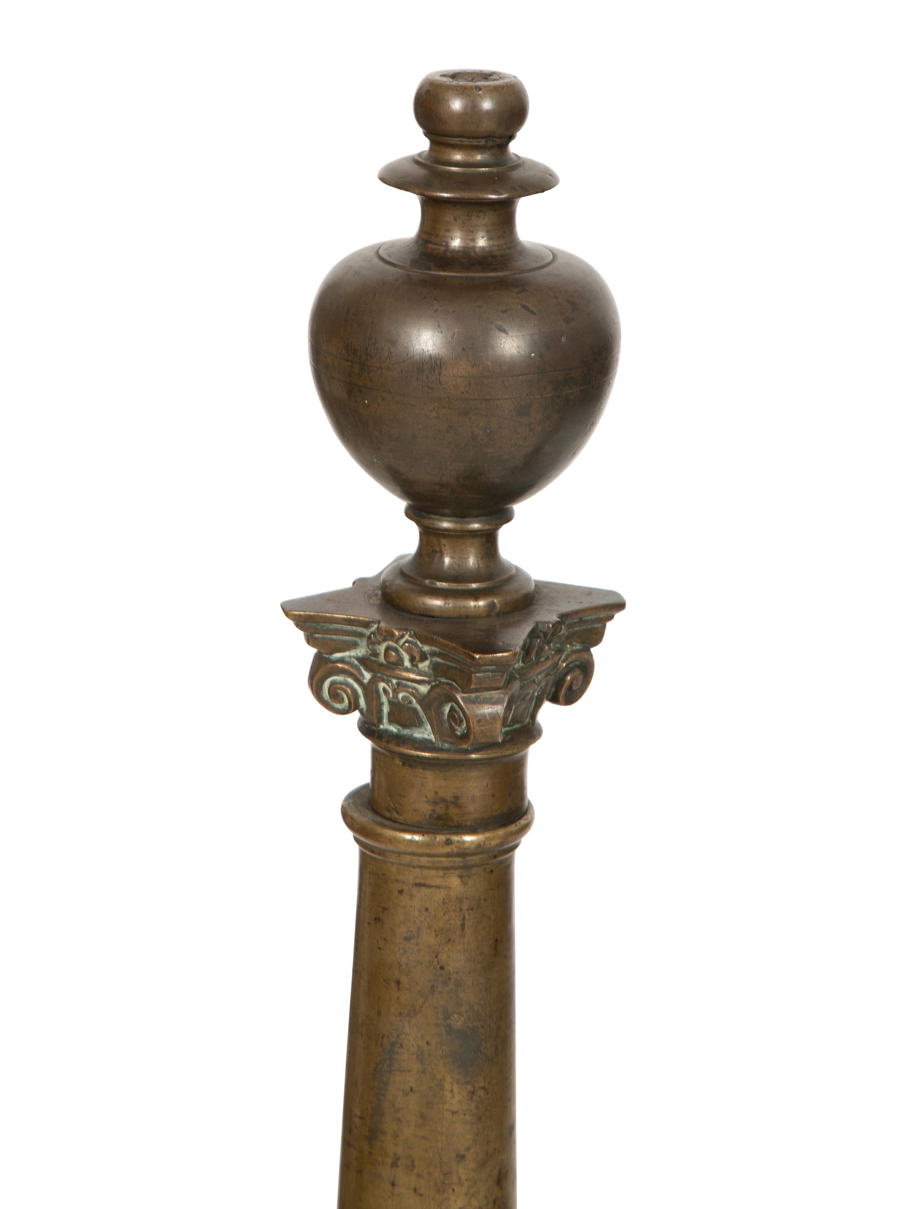 A Pair of Large Patinated Metal Andirons
