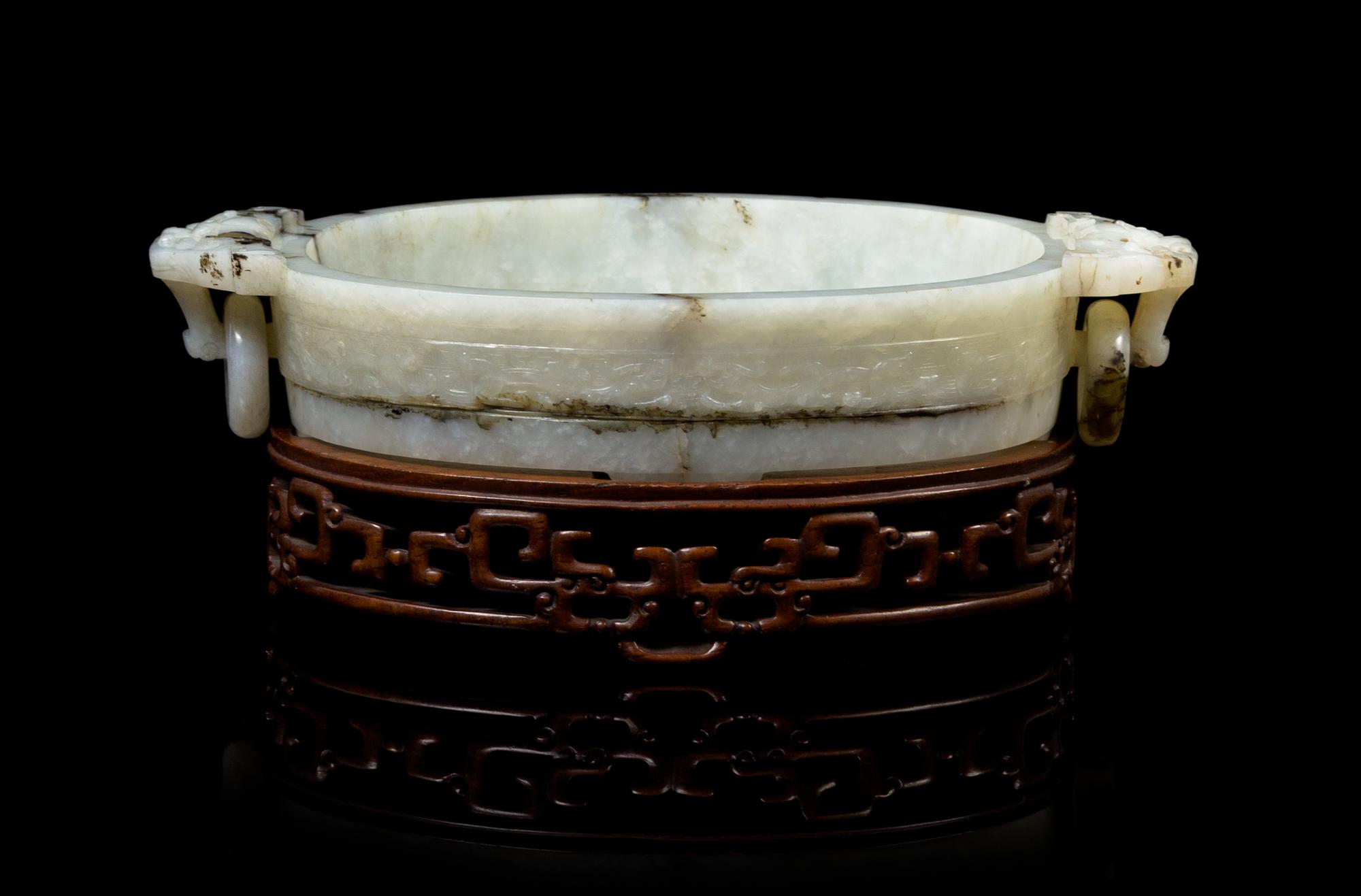 A Chinese White Jade Marriage Bowl 18TH/19TH CENTURY, LIKELY QIANLONG PERIOD Width over handles 7 1/4 inches. — 18TH/19TH CENTURY, LIKELY QIANLONG PERIOD