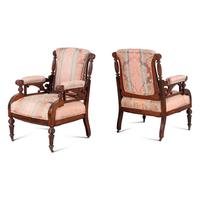 A Pair of Victorian Walnut Armchairs with Associated Foot Stools