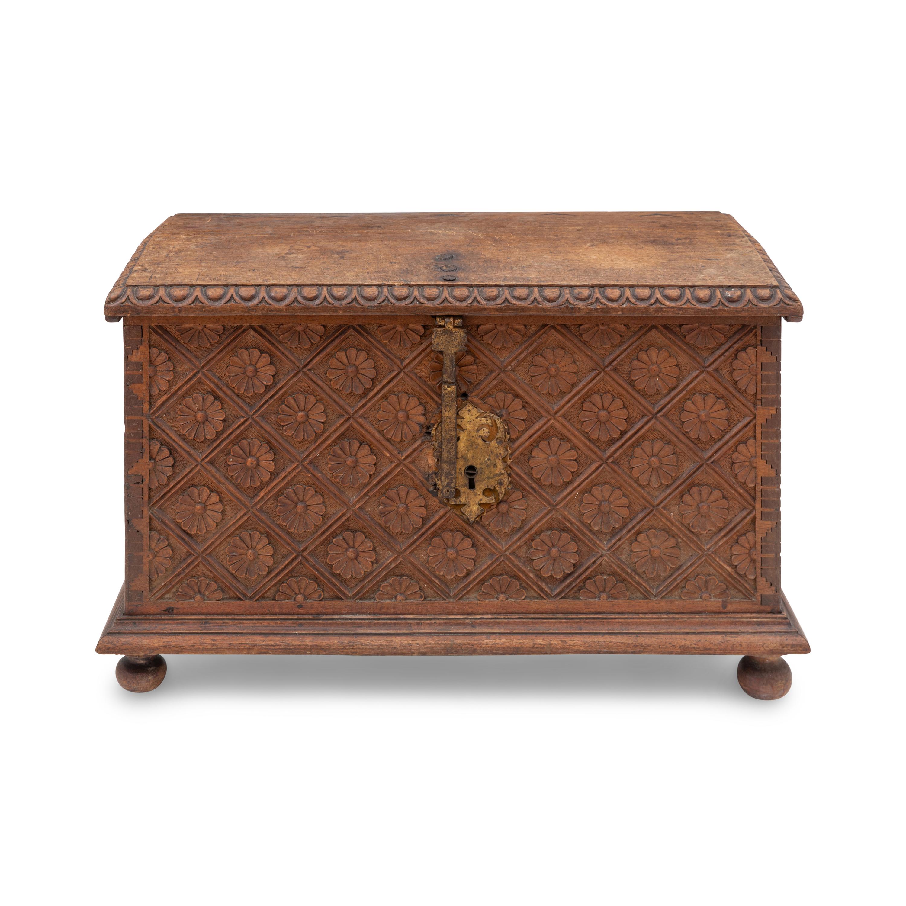 A Spanish Carved Walnut and Gilt Iron Chest