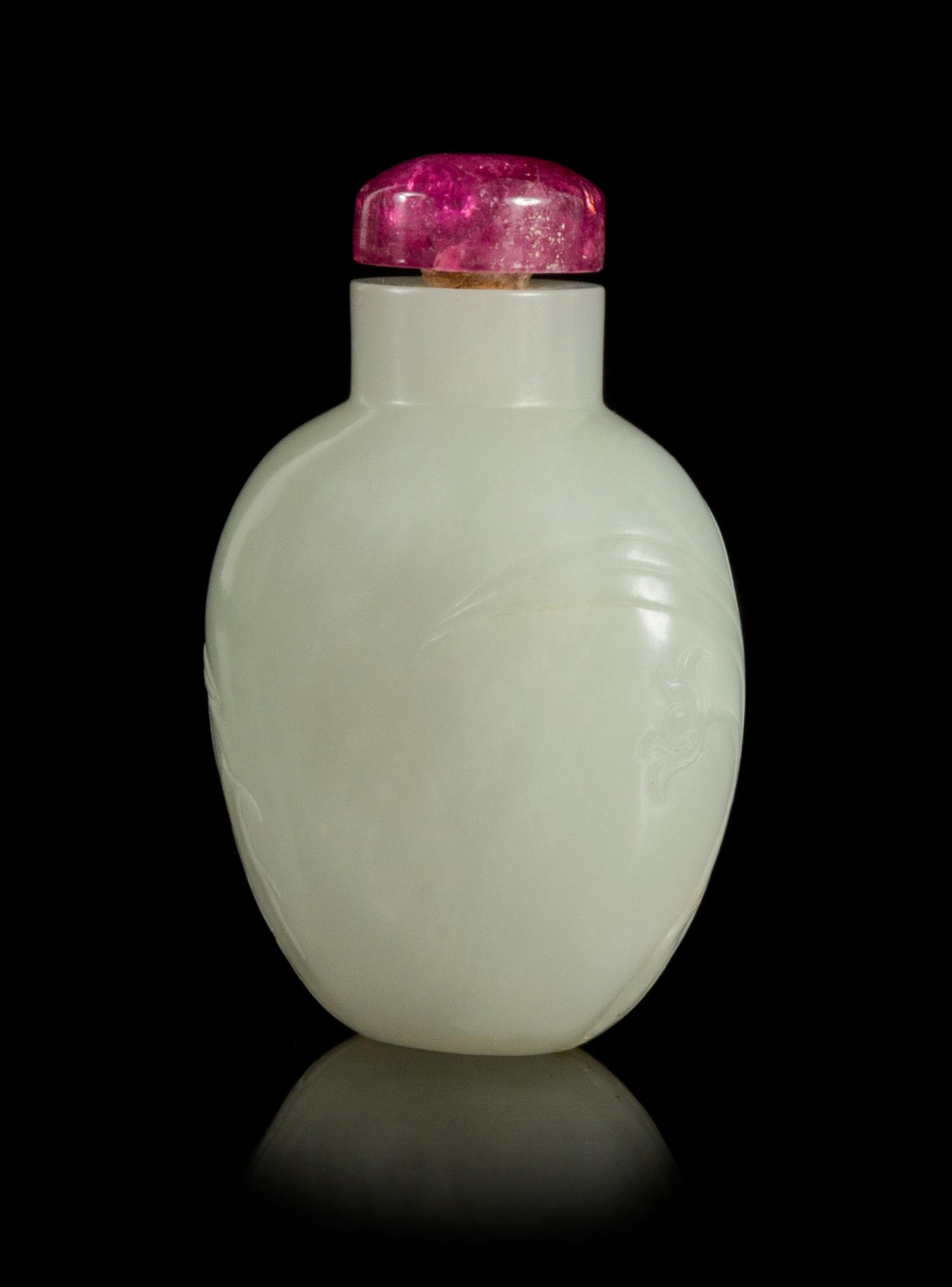 A Carved White Jade Snuff Bottle Height 2 1/2 inches.