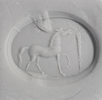 A Roman Bloodstone Ring Stone with a Horse and Palm Tree