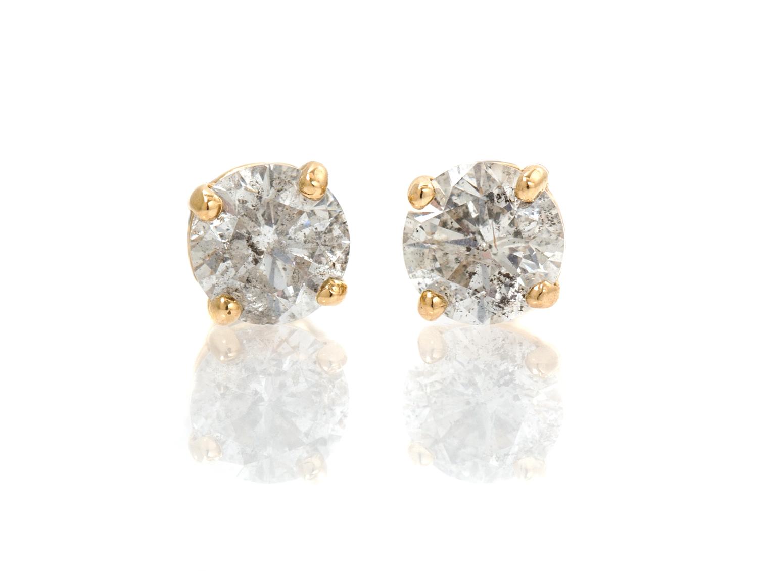 A Pair of 14 Karat Yellow Gold and Diamond Stud Earrings, 0.50 dwts.