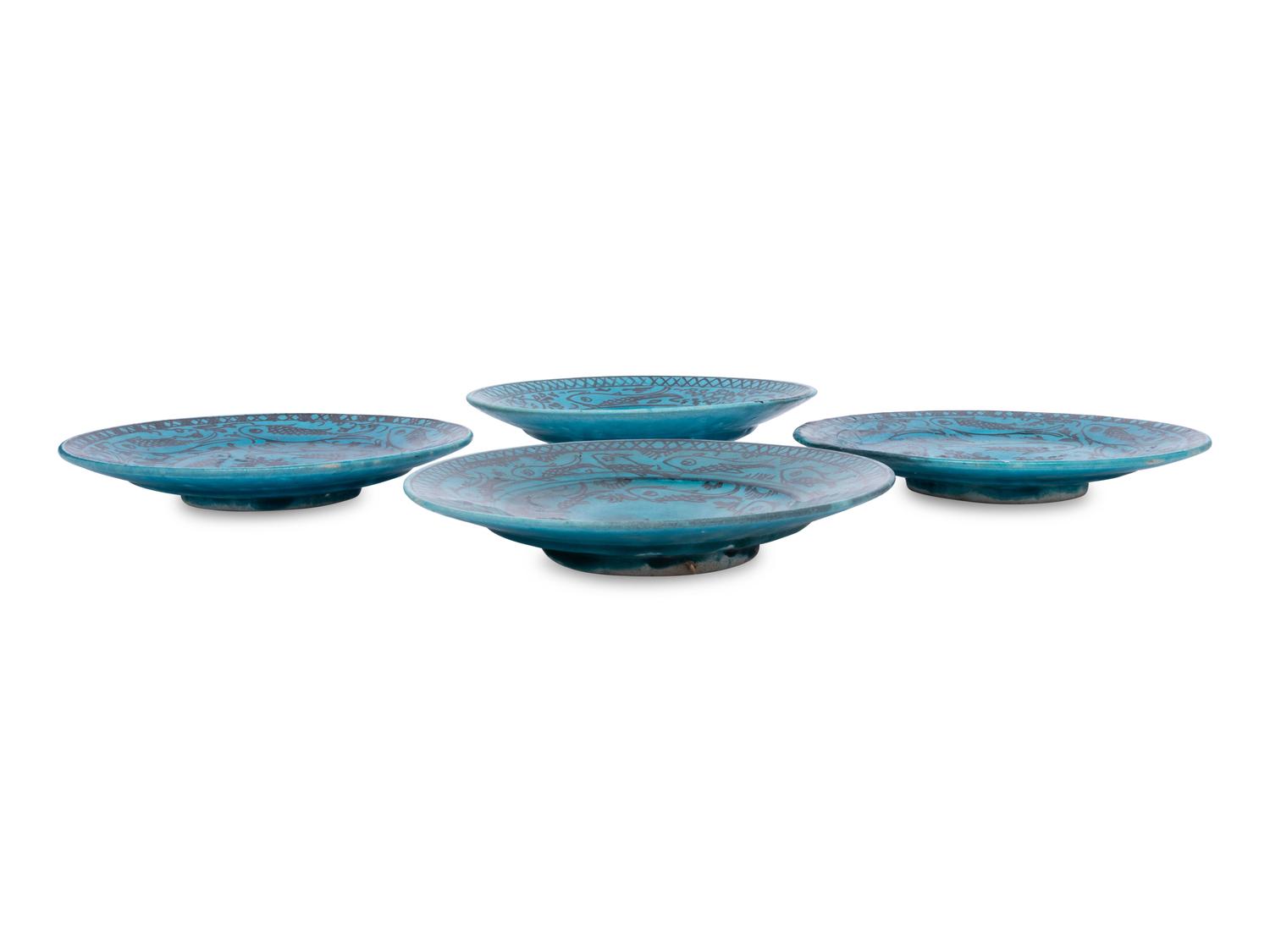 A Set of Four Persian Turquoise Glazed Earthenware Plates