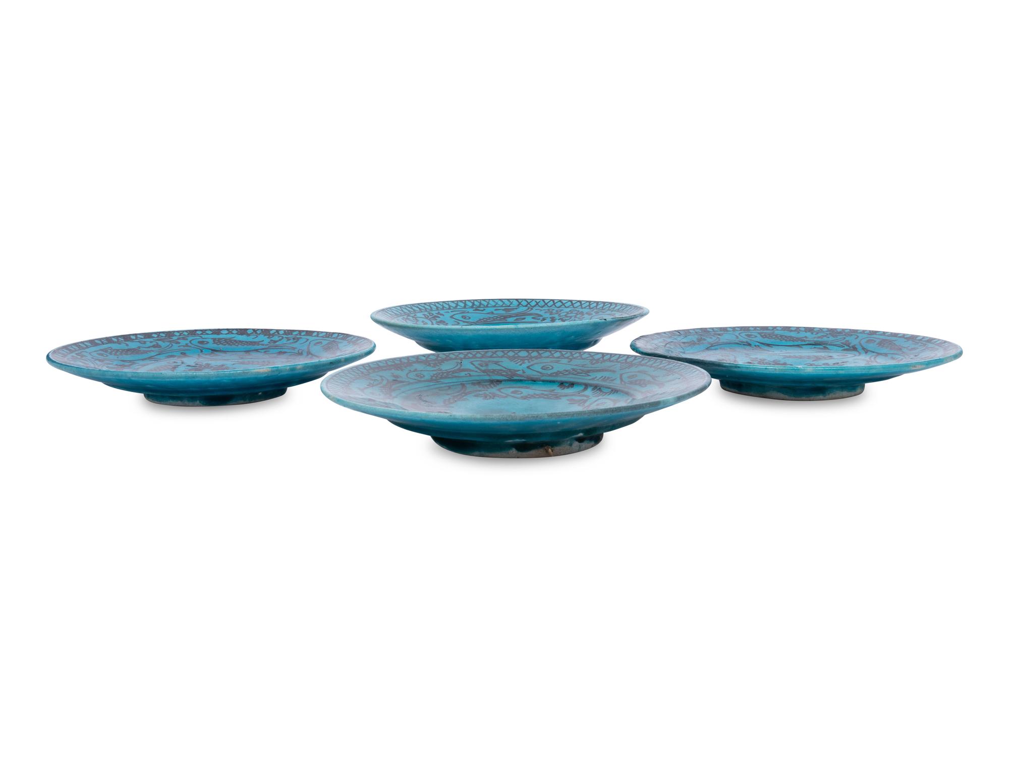 A Set of Four Persian Turquoise Glazed Earthenware Plates