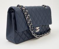 A Chanel Navy Caviar Classic Double Flap Handbag, 10" x 6" x 2.5"; Strap Drop: 9.5".