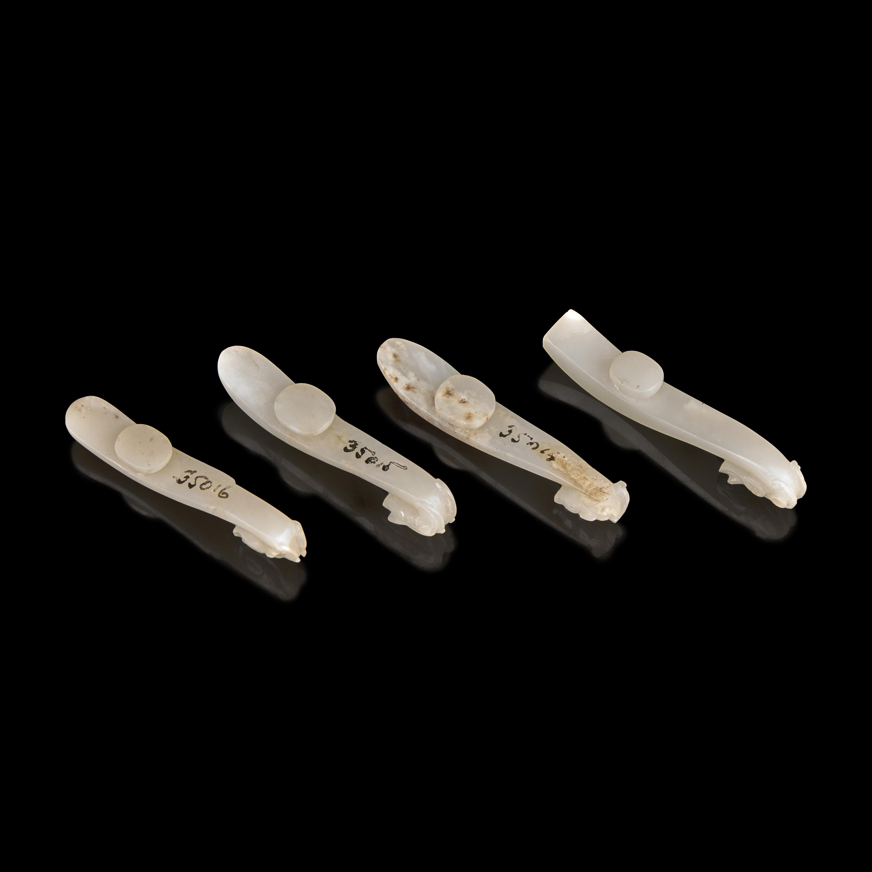 Four Chinese Greyish White Jade "Dragon" Head Belt Hooks, Qing Dynasty — 清 灰白玉龍鉤四件