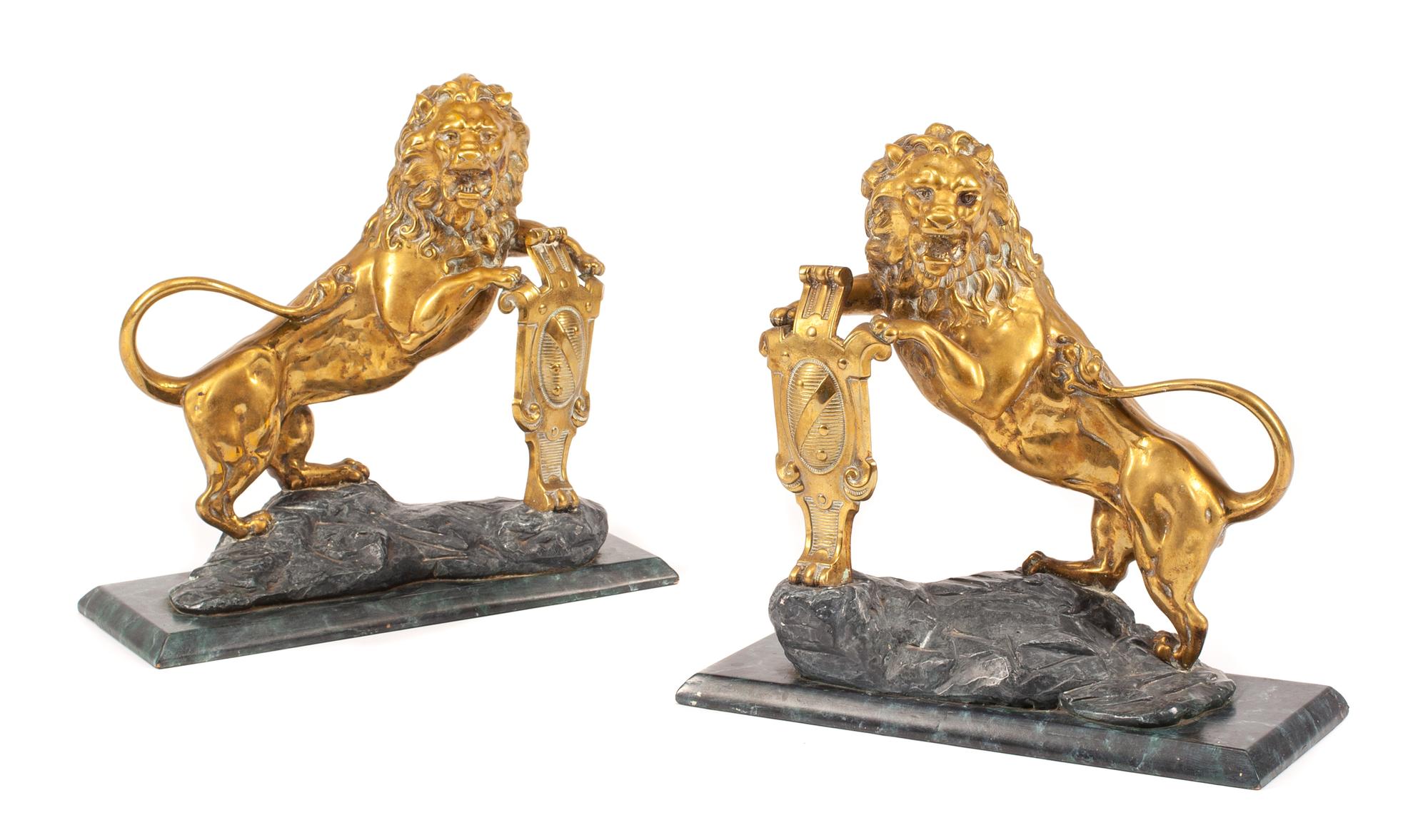 A Pair of English Gilt Bronze Lion Ornaments Width of base 16 inches.