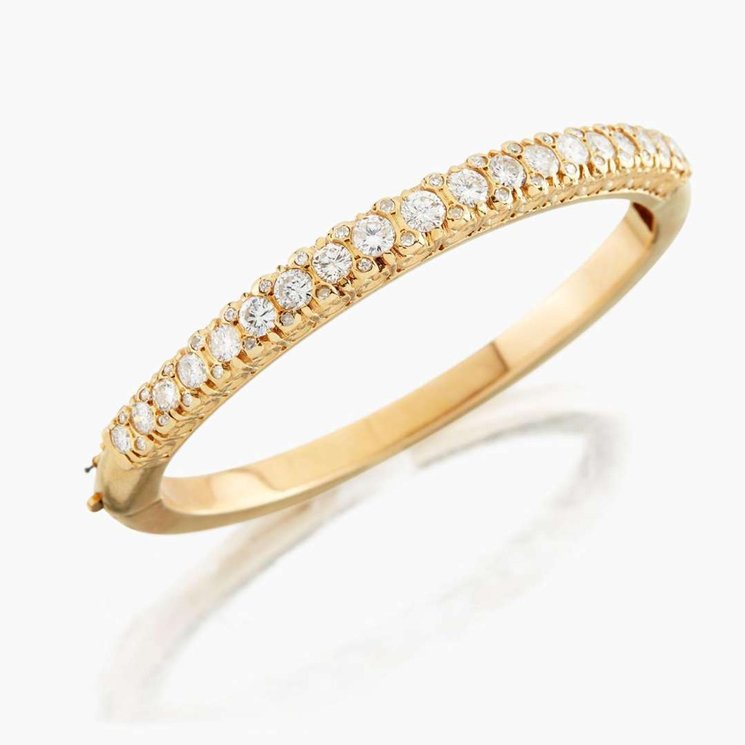 A gold and diamond bangle bracelet