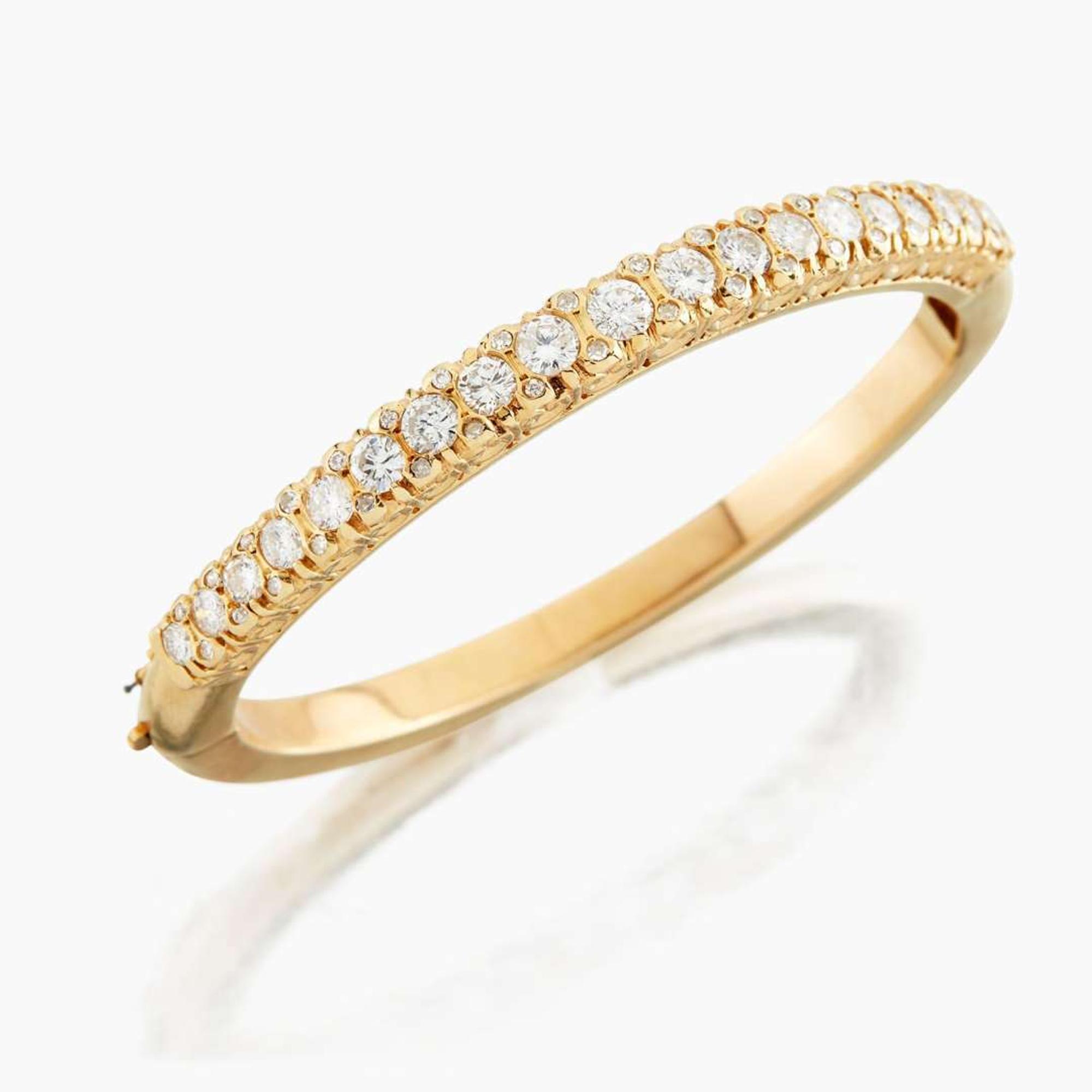 A gold and diamond bangle bracelet