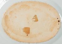 A Pair of Chinese Export Porcelain Armorial Platters Raised on Later Mahogany Stands