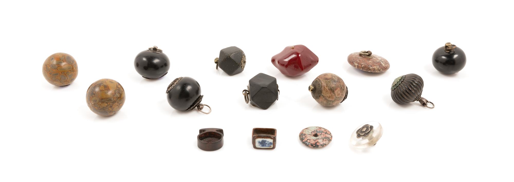 Thirteen Chinese Hardstone and Glass Pendants Diameter of largest 2 inches.