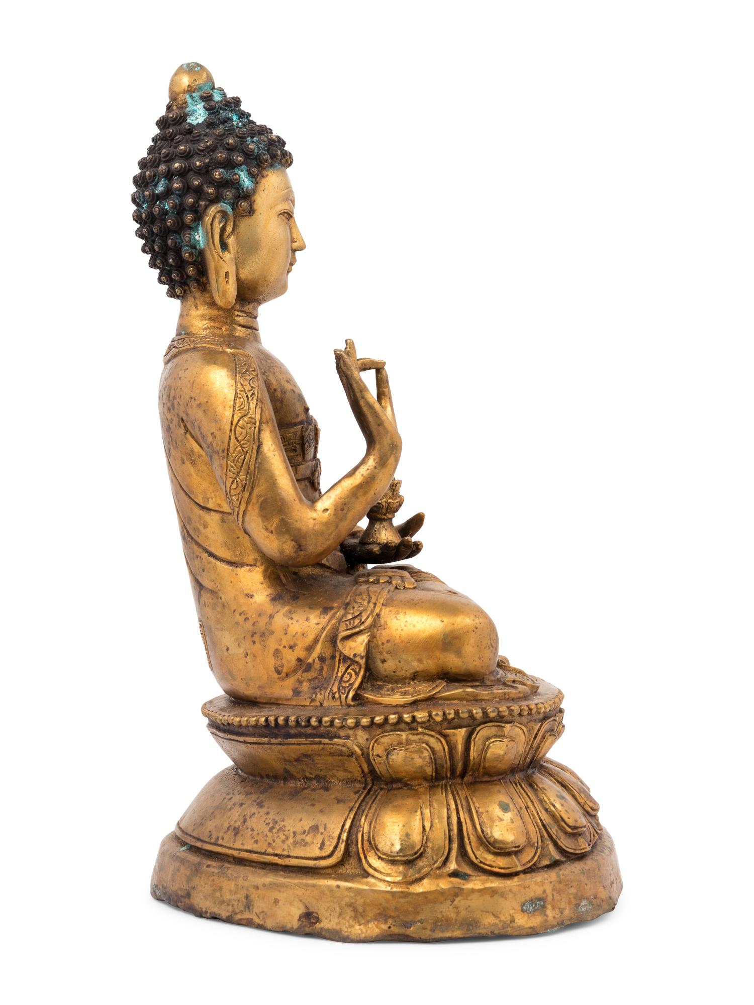 A Gilt Bronze Seated Buddha Figure on Lotus Flower Base