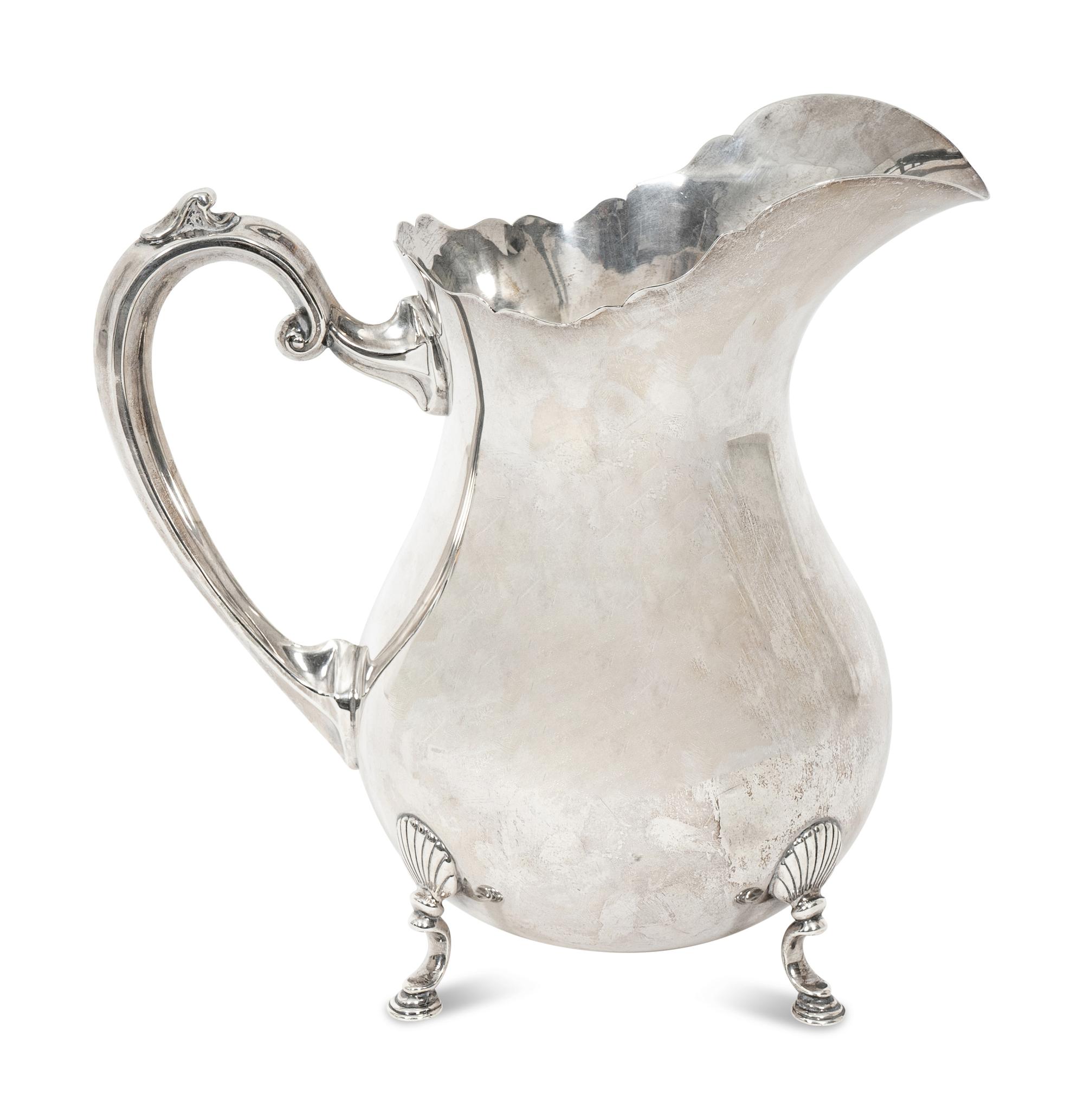 An American Fisher Sterling Silver Water Pitcher and A Cartier Sterling Silver Novelty Model of a Watering Can