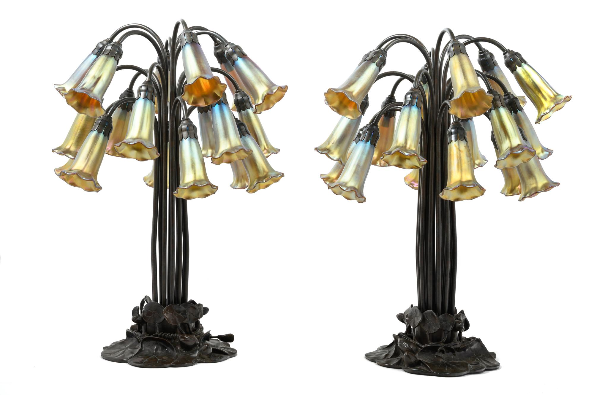 A Pair of Art Nouveau Style Patinated Metal and Iridescent Glass Eighteen-Light Tulip Lamps