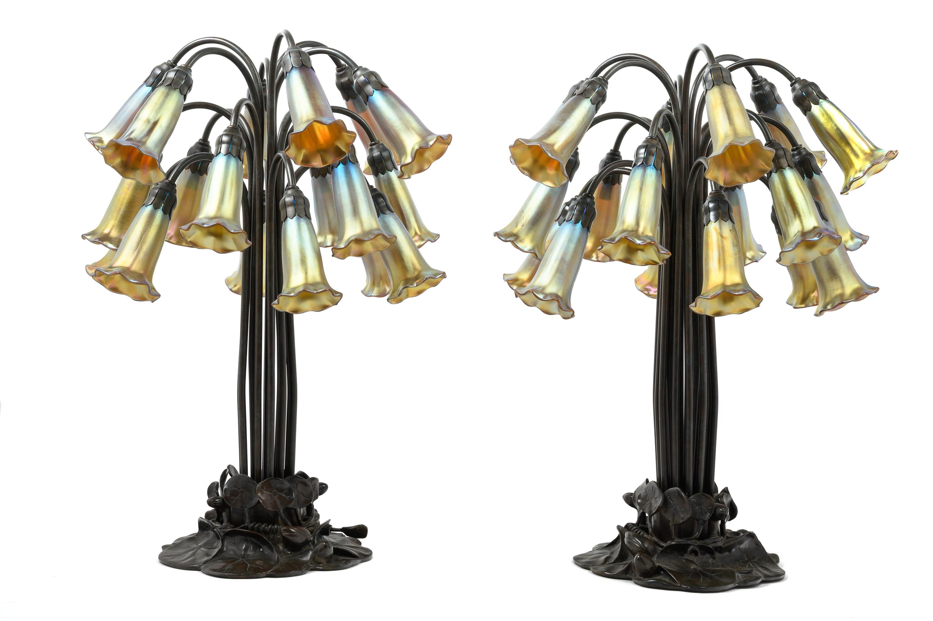A Pair of Art Nouveau Style Patinated Metal and Iridescent Glass Eighteen-Light Tulip Lamps
