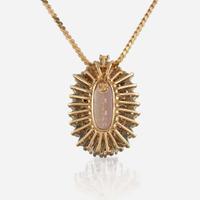 A topaz, diamond, and gold pendant