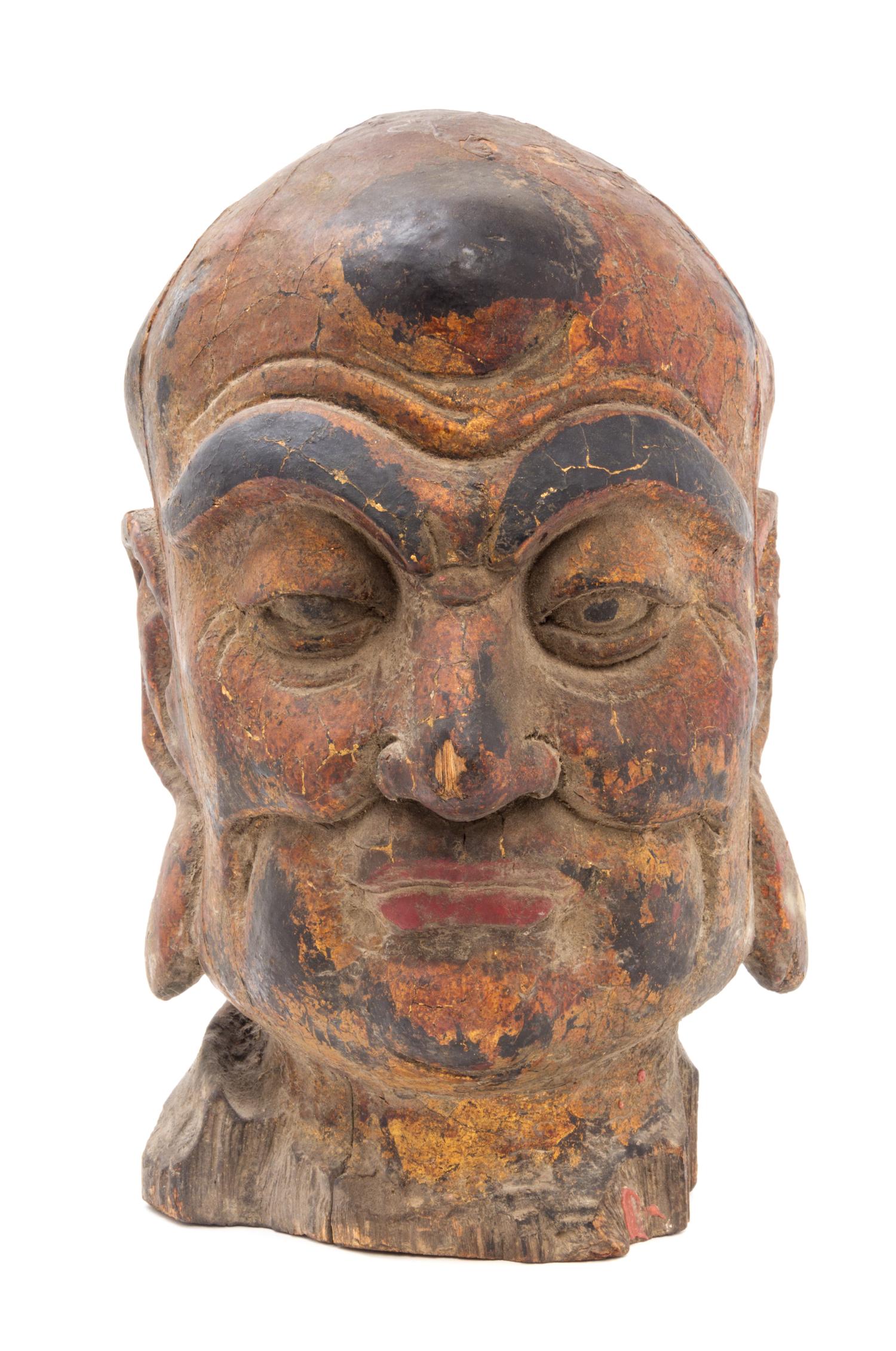 A Painted Wood Head of a Luohan Height 19 inches.