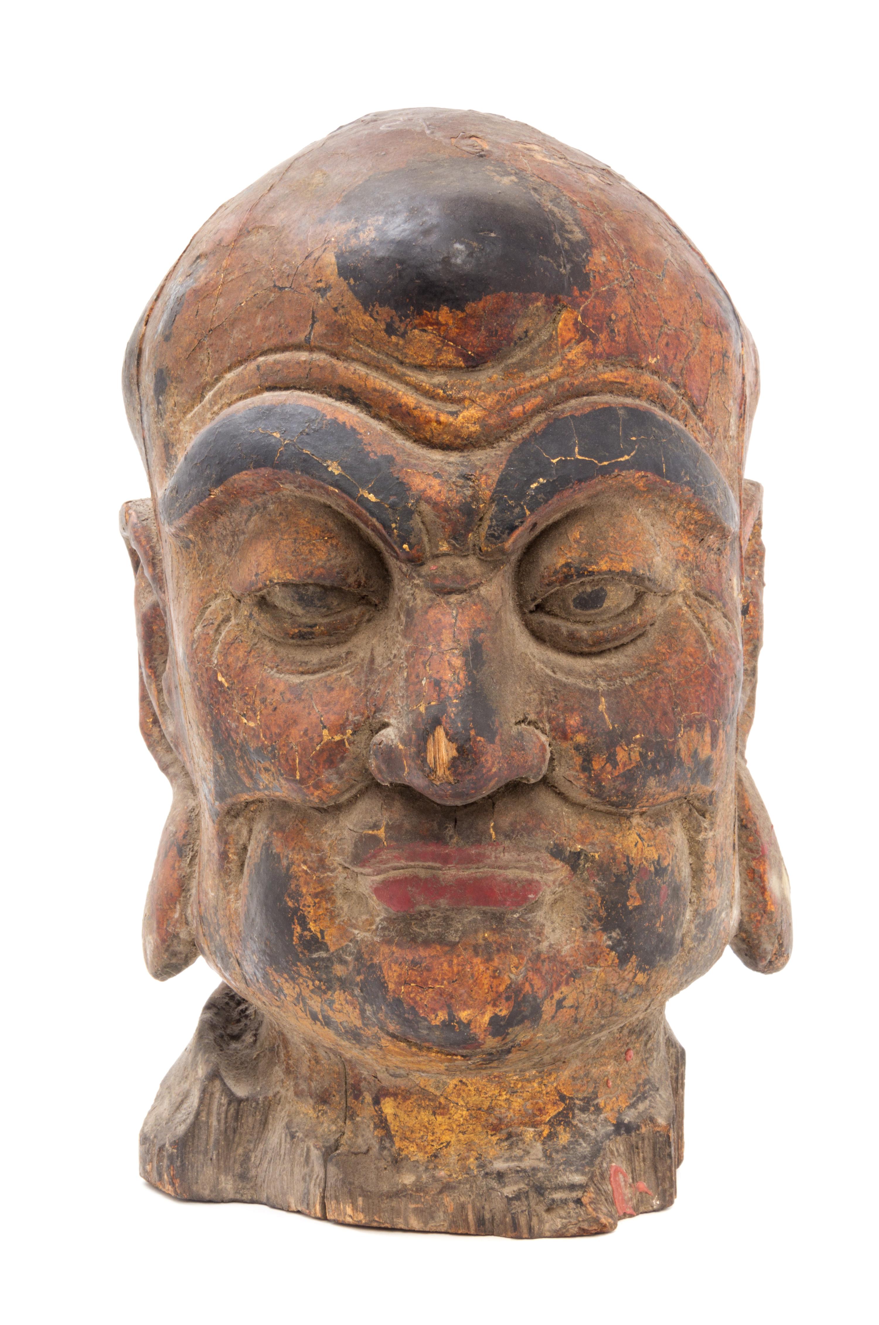 A Painted Wood Head of a Luohan Height 19 inches.