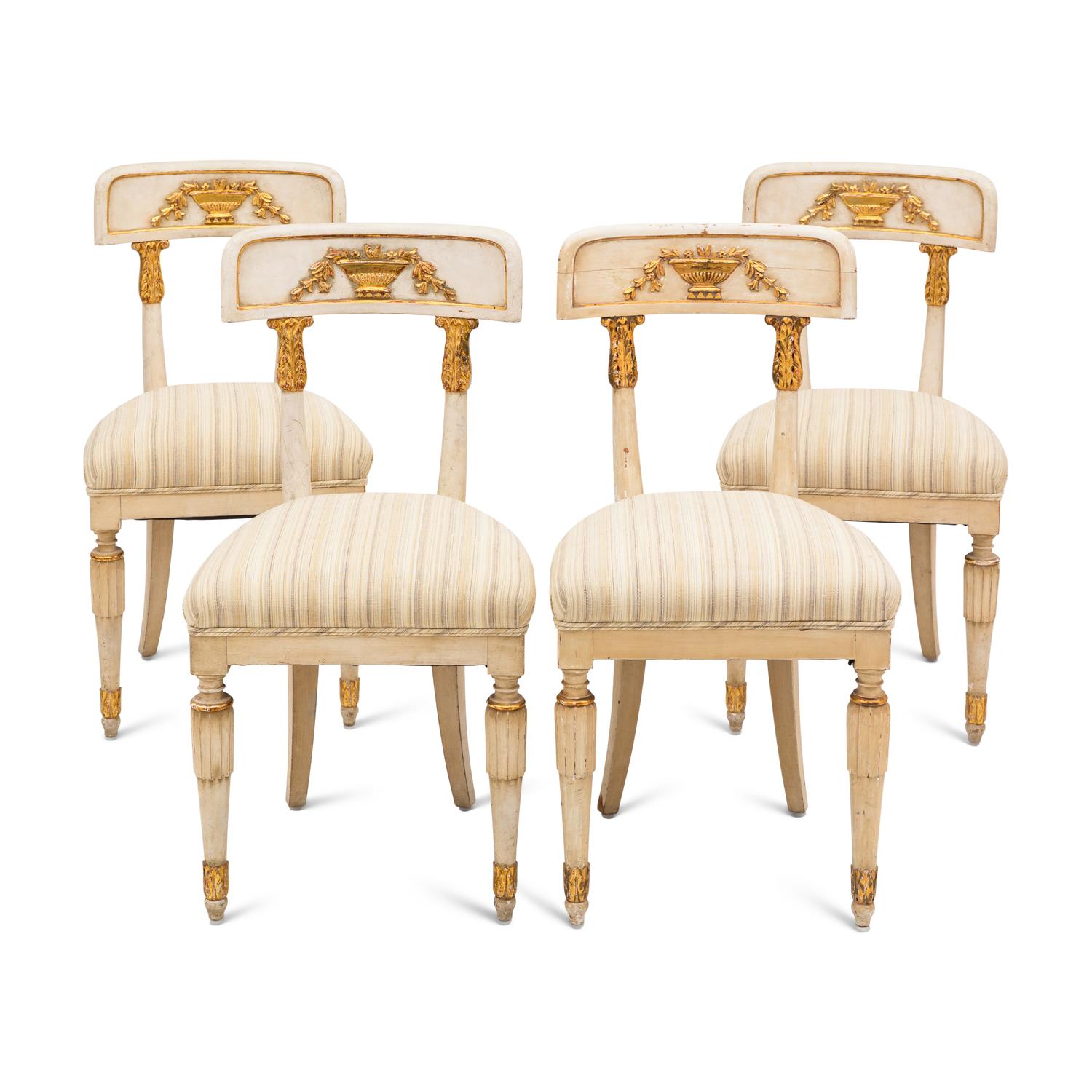 A Suite of Four Gustavian Style Painted and Parcel Gilt Chairs