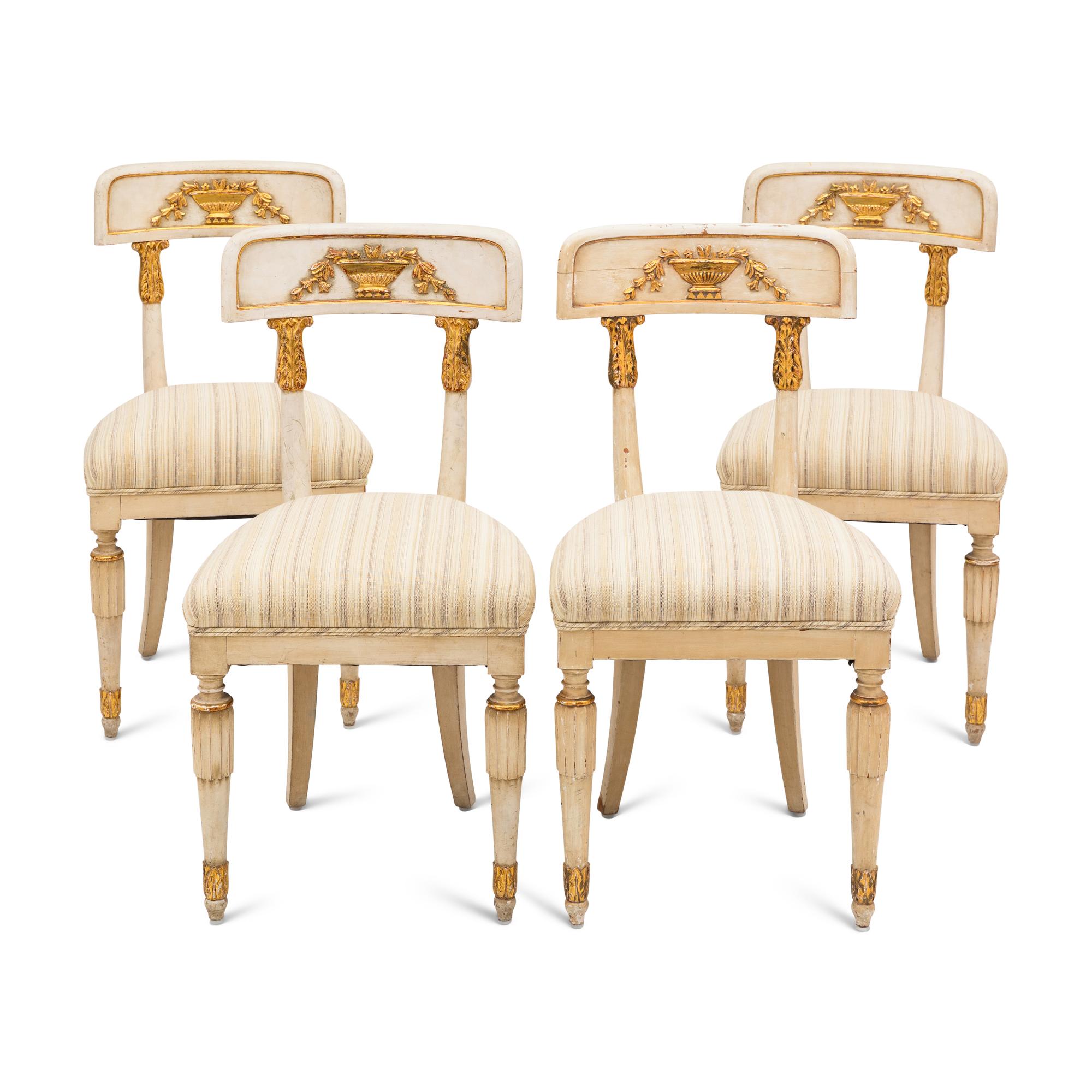 A Suite of Four Gustavian Style Painted and Parcel Gilt Chairs