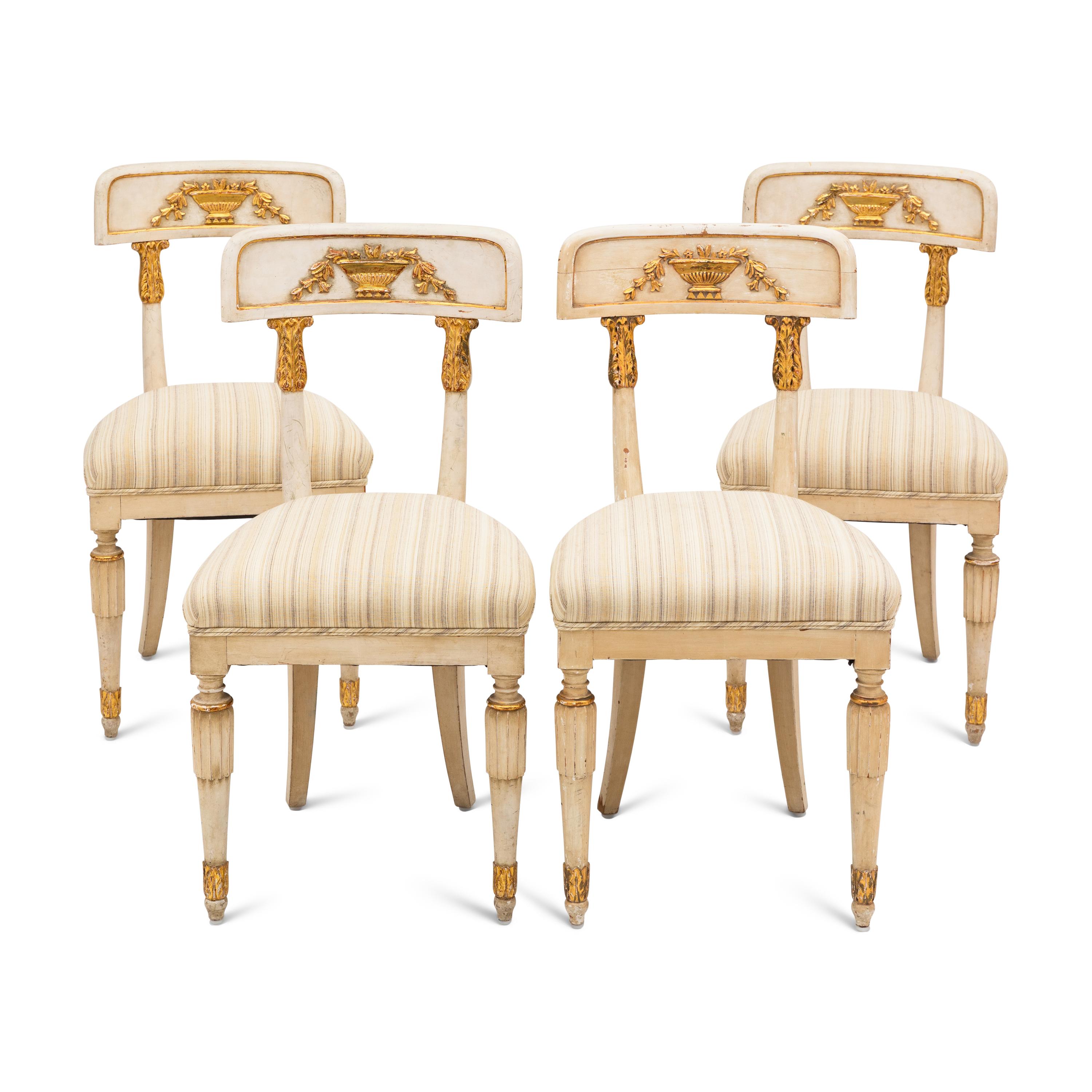 A Suite of Four Gustavian Style Painted and Parcel Gilt Chairs