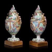 A Pair of Chinese Export Canton Famille Rose Porcelain Covered Urns, Early 19th Century — 清晚期 外銷廣彩人物故事圖獎杯形賞瓶一對