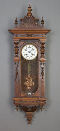 A German Walnut Regulator Clock, Height 42 x width 14 1/2 inches.