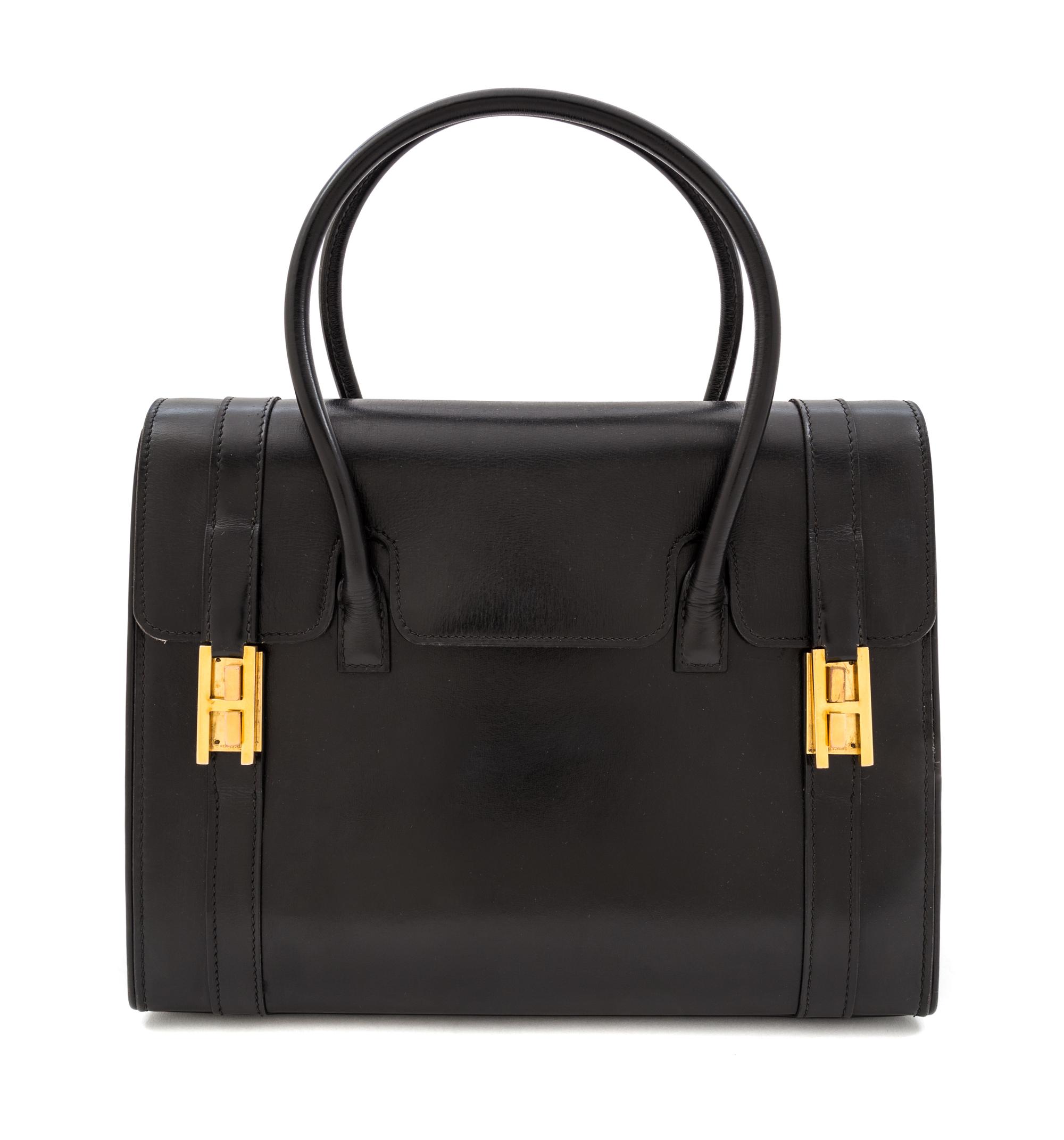 An Hermes Black Leather Drag Handbag, 10" x 8" x 4".