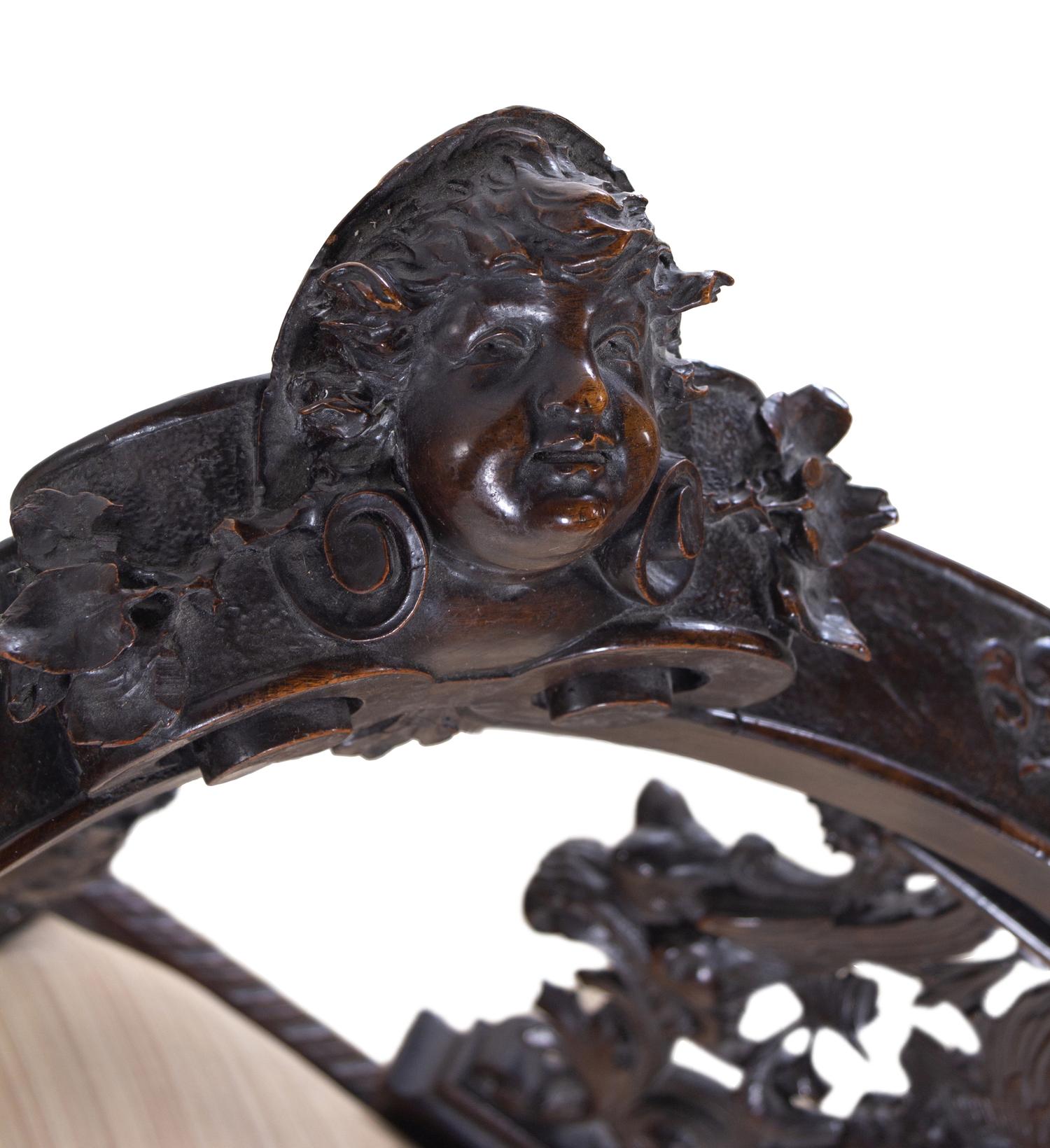 A Renaissance Revival Carved Walnut Corner Chair