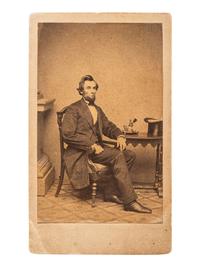 [LINCOLN, Abraham (1809-1865)]. BRADY, Mathew (1822-1896), artist. "Inkwell pose" CDV of Lincoln. New York: E. & H.T. Anthony, [1861].