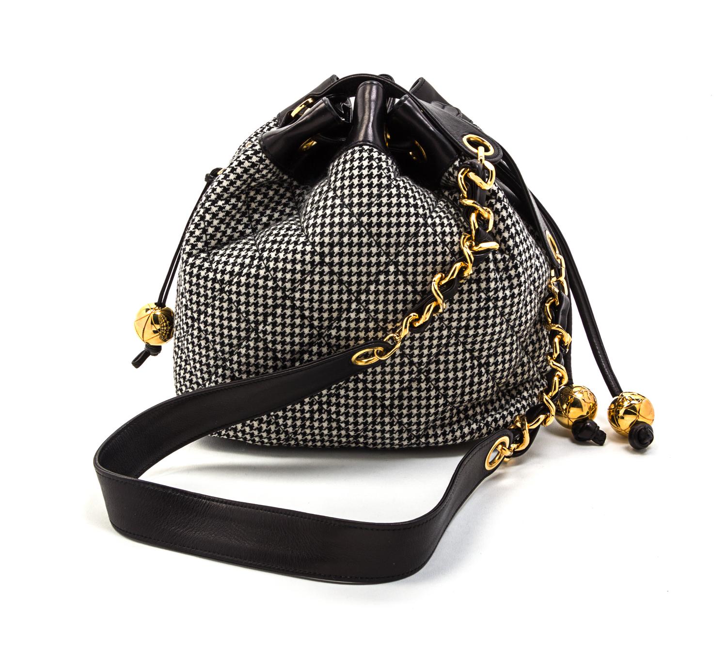 A Chanel Black and White Houndstooth Wool and Black Leather Trim Bucket Bag, 8 1/2 x 7 1/2 x 5 1/2 inches.