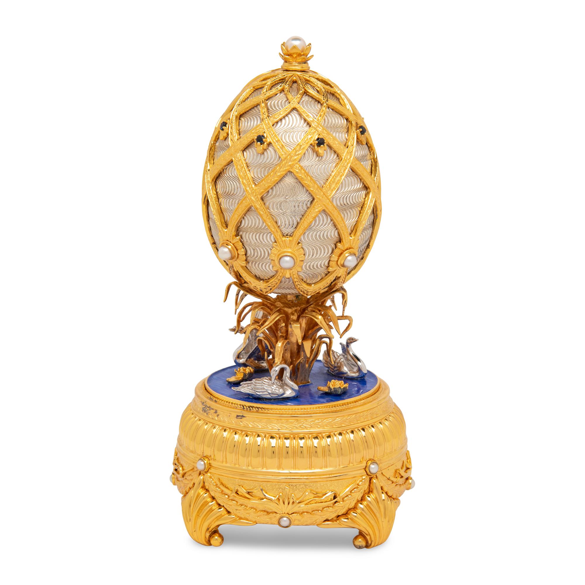 A Silver, Gilt and Enamel Decorated Swan Lake Egg-Form Music Box