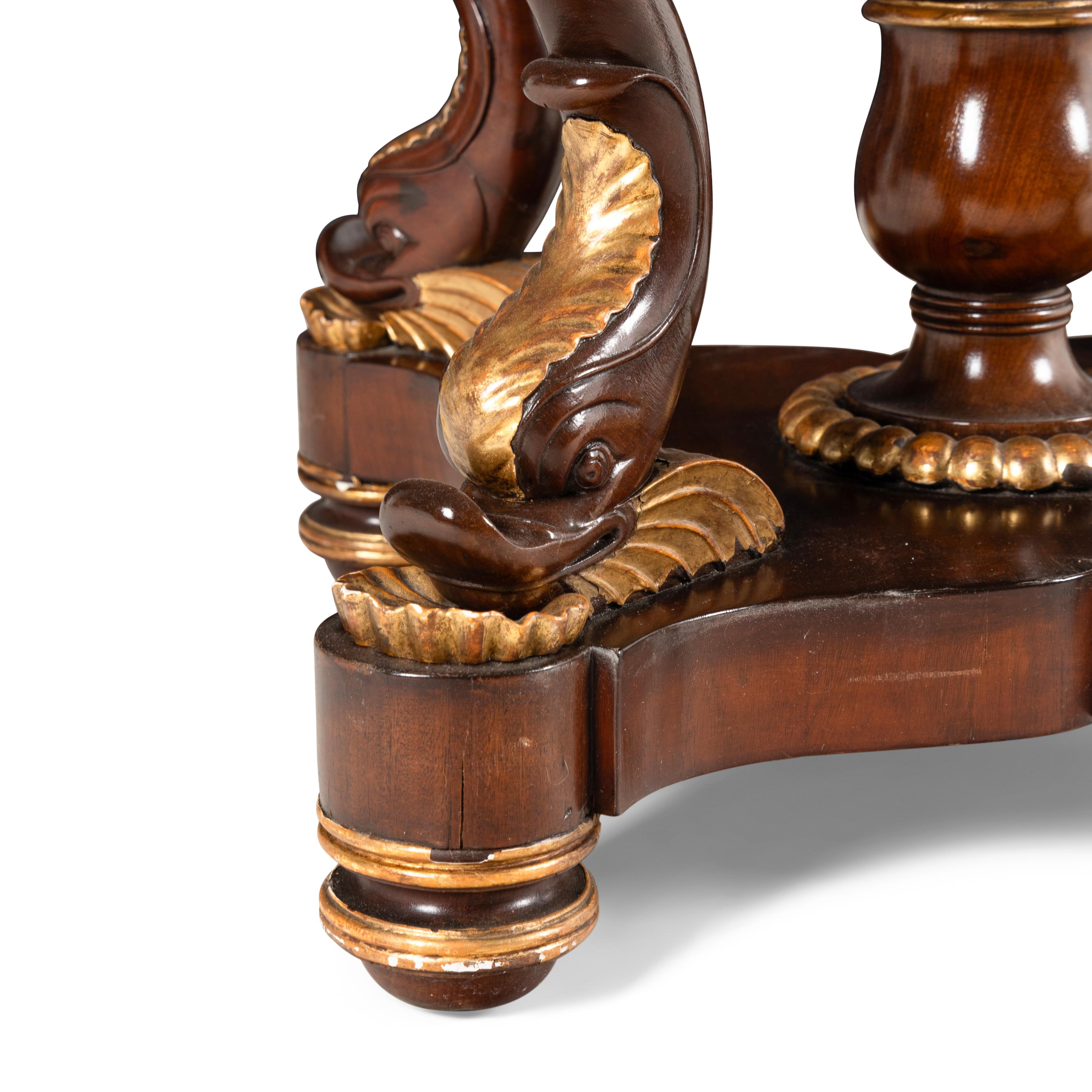 A Late Regency Parcel-Gilt Mahogany and Satinwood Marble-Inset Center Table