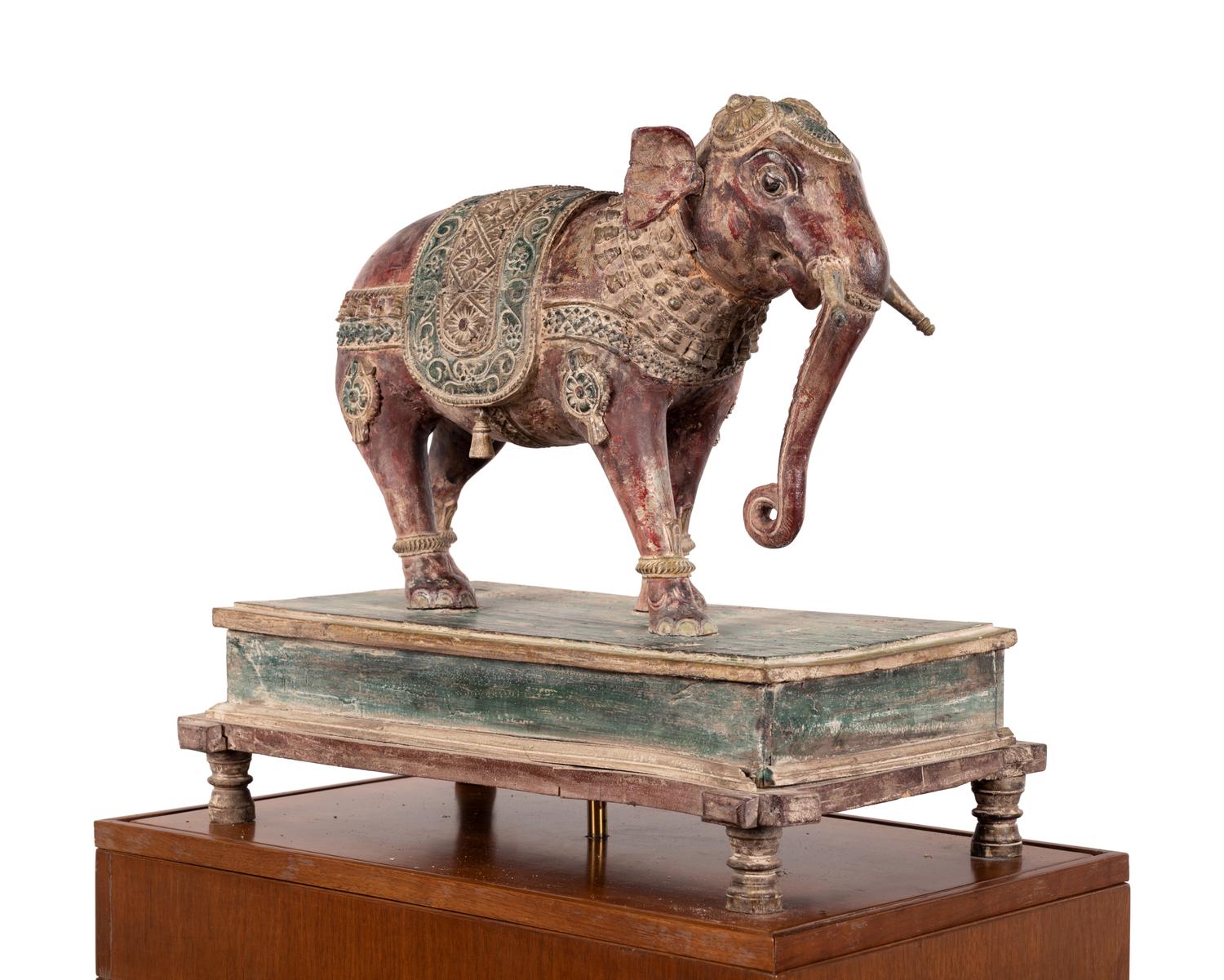 An Indian Carved Wood Model of an Elephant in a Walnut and Glass Vitrine