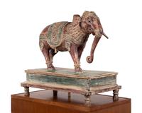 An Indian Carved Wood Model of an Elephant in a Walnut and Glass Vitrine