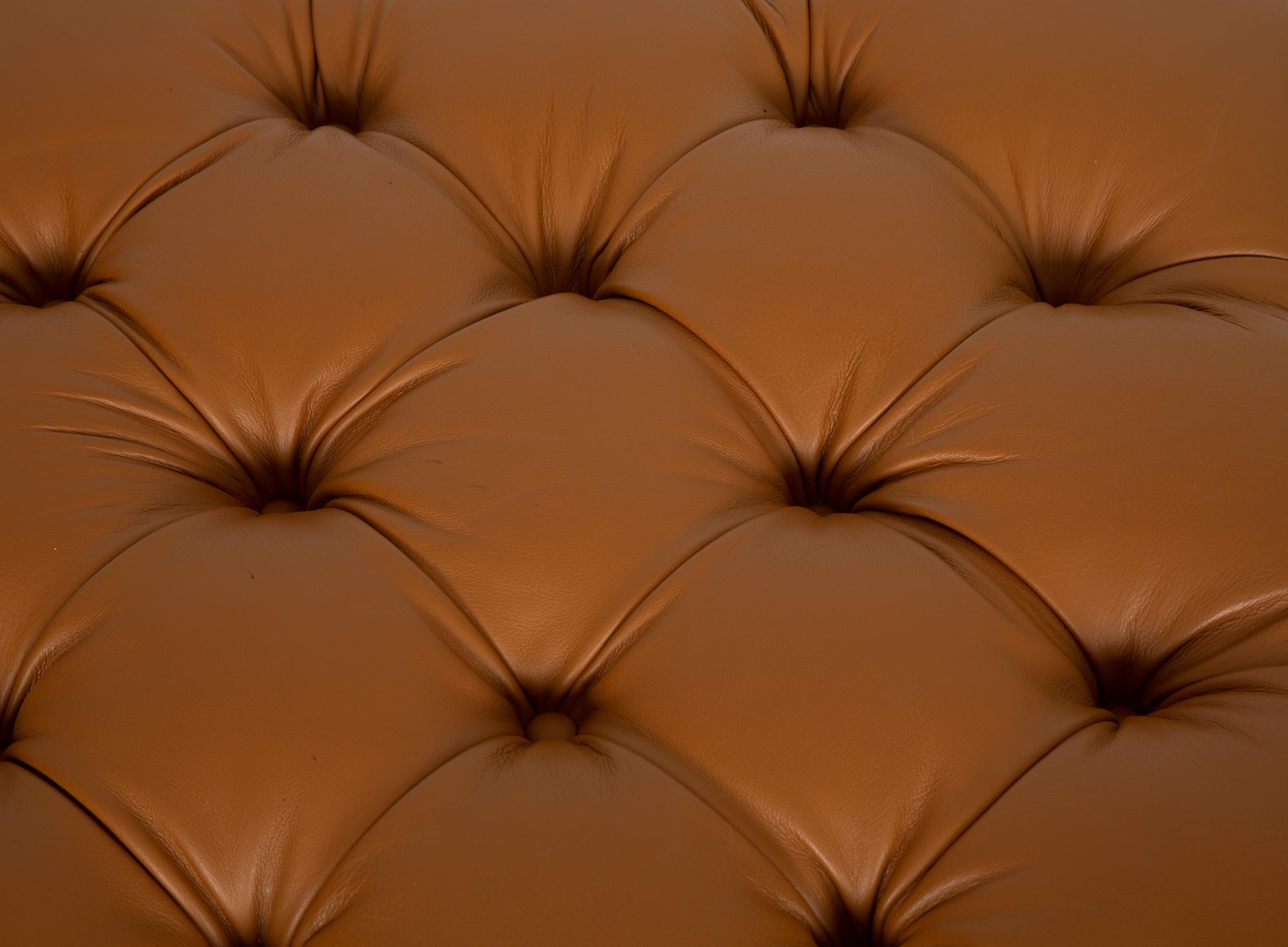 A Regency Style Brown Tufted Leather Upholstered Ottoman
