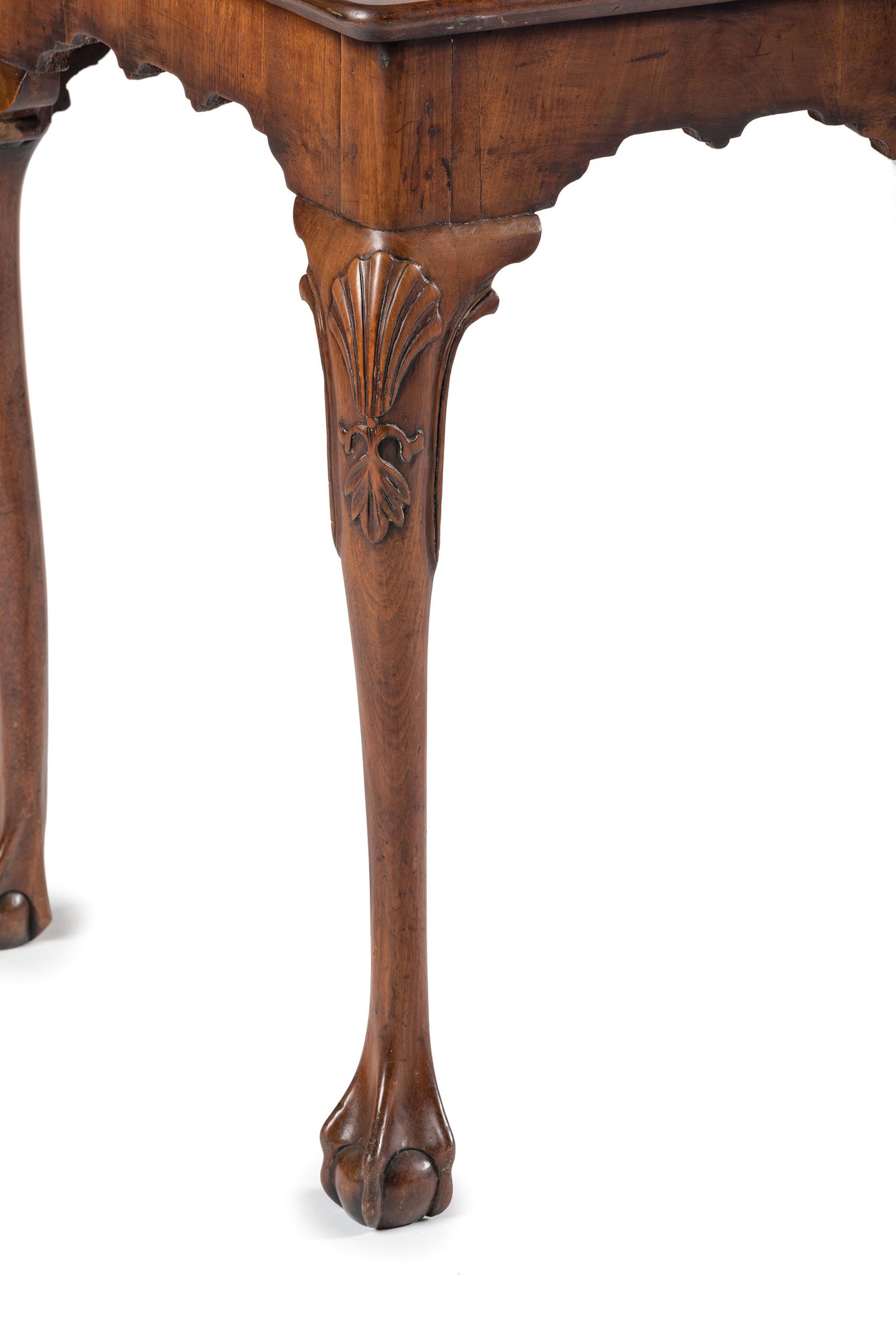 A Queen Anne Shell-Carved and Veneered Walnut Dish-Top Claw-and-Ball Foot Tea Table
