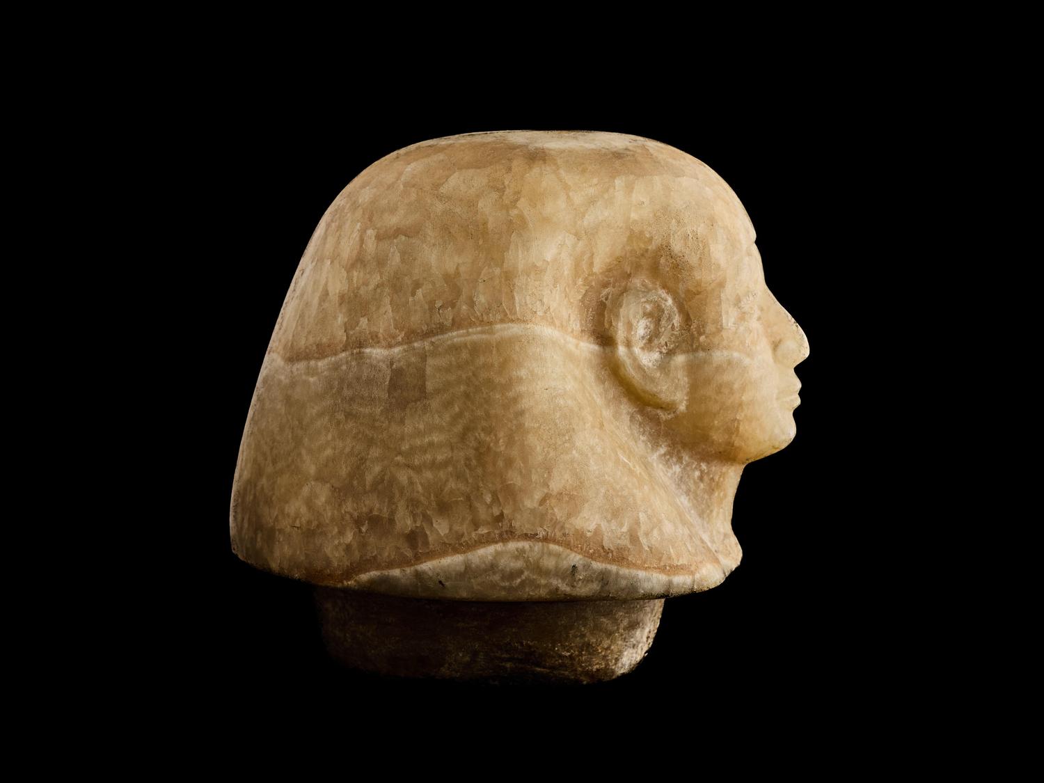 An Egyptian Alabaster Canopic Jar Lid